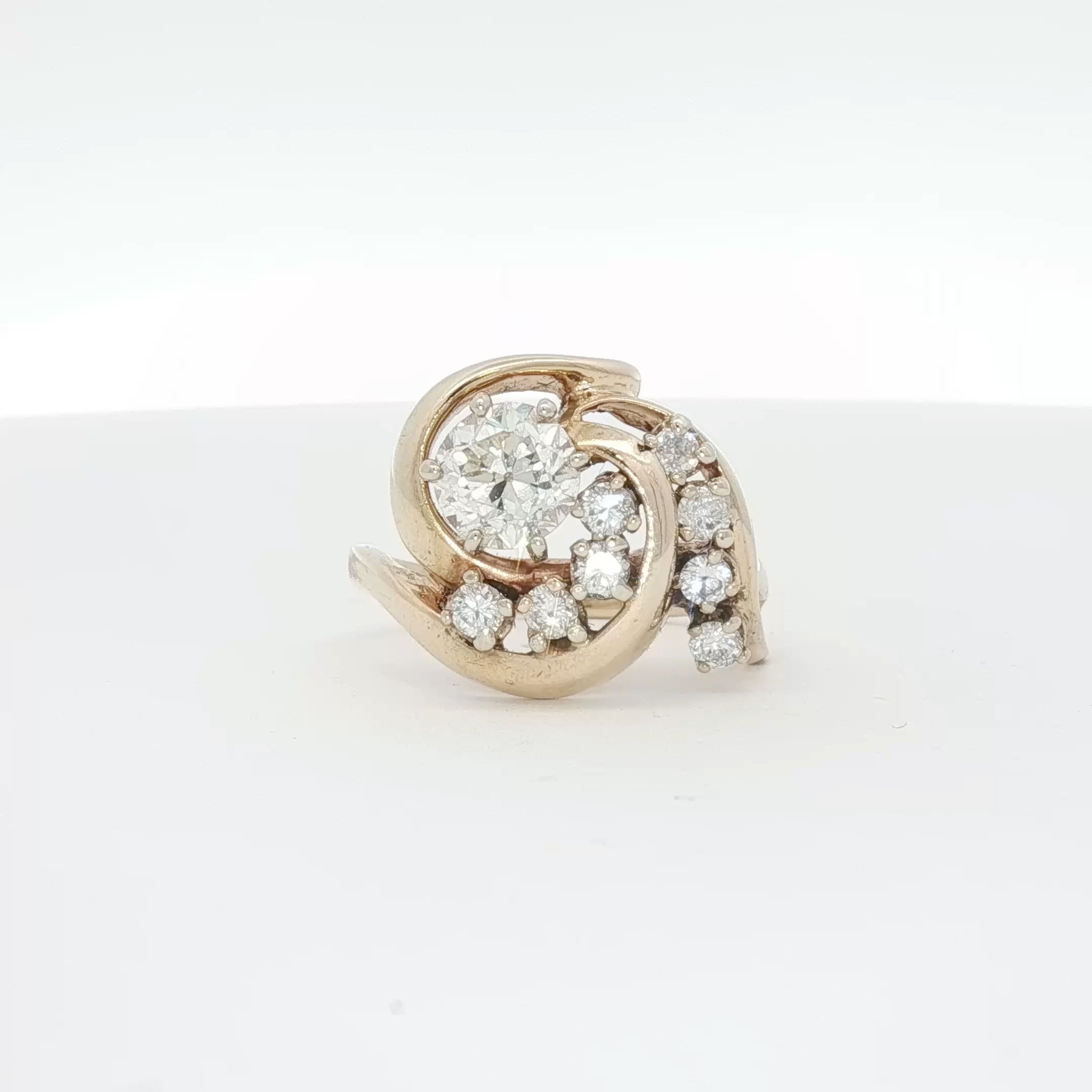 14K yellow gold diamond swirl ring featuring sparkling diamonds and elegant design, crafted by Gold & Beyond.