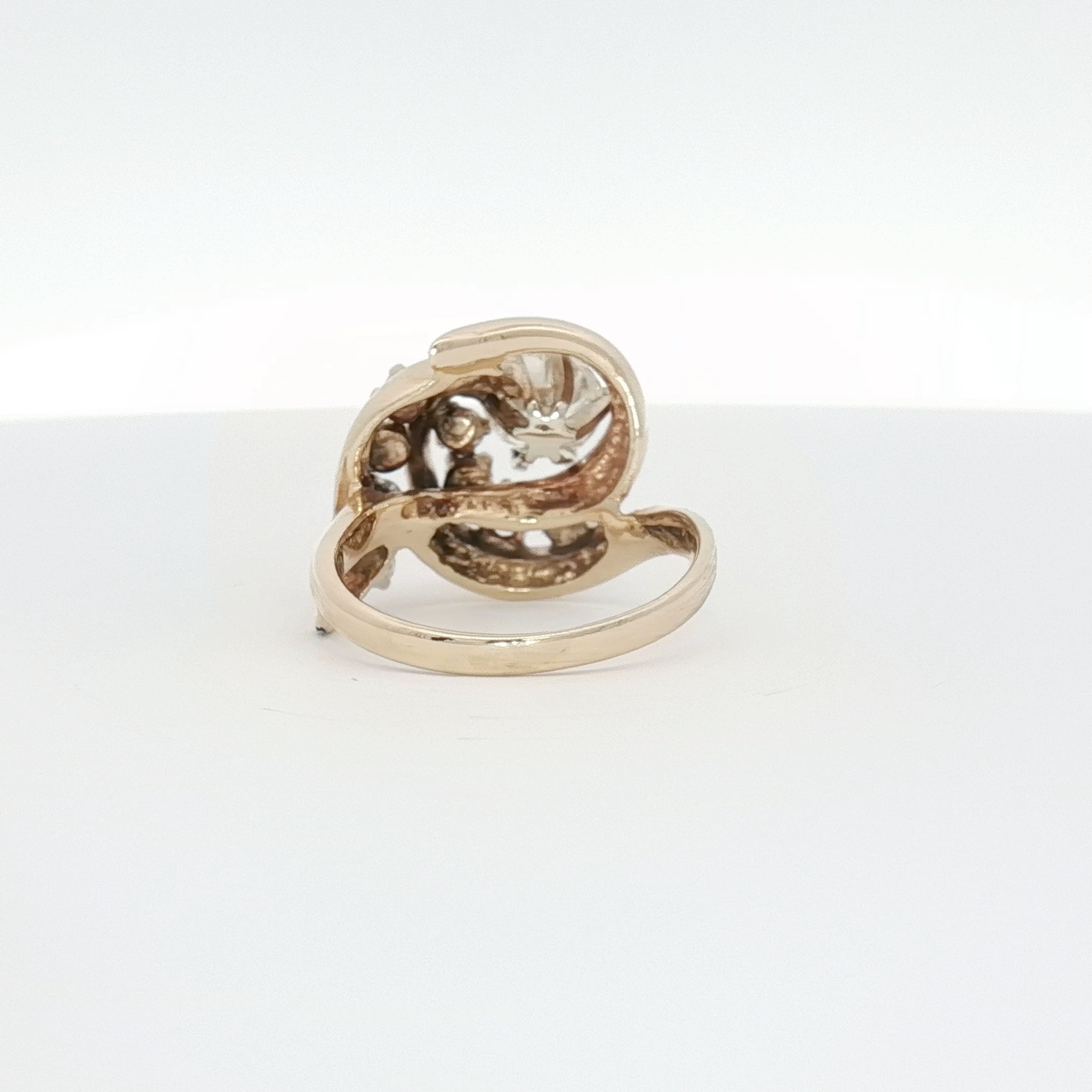 14K yellow gold diamond swirl ring from Gold & Beyond featuring sparkling diamonds and an elegant, flowing design.