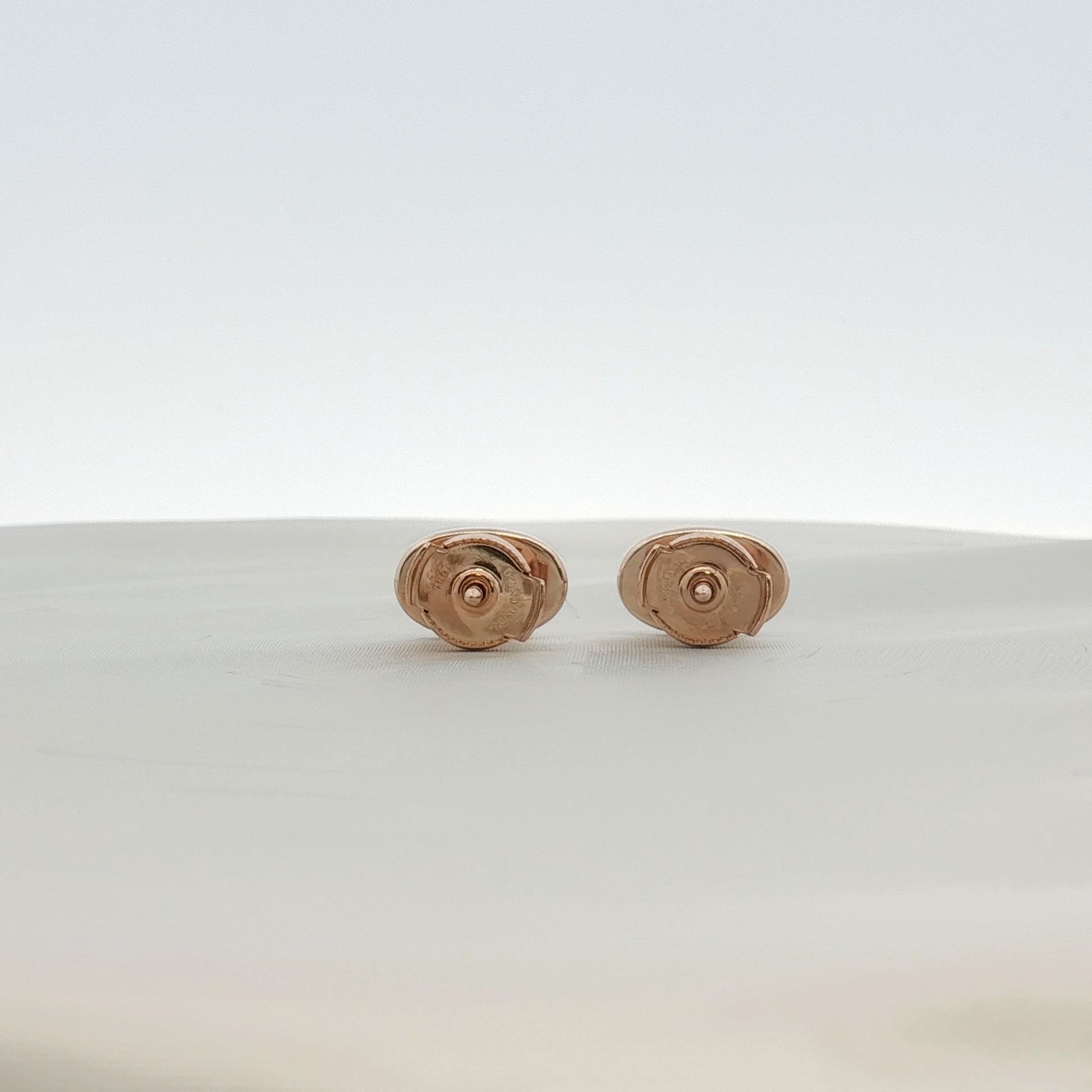 Hermès oval diamond stud earrings in jewelry, showcasing elegant diamond details and sleek metal setting.