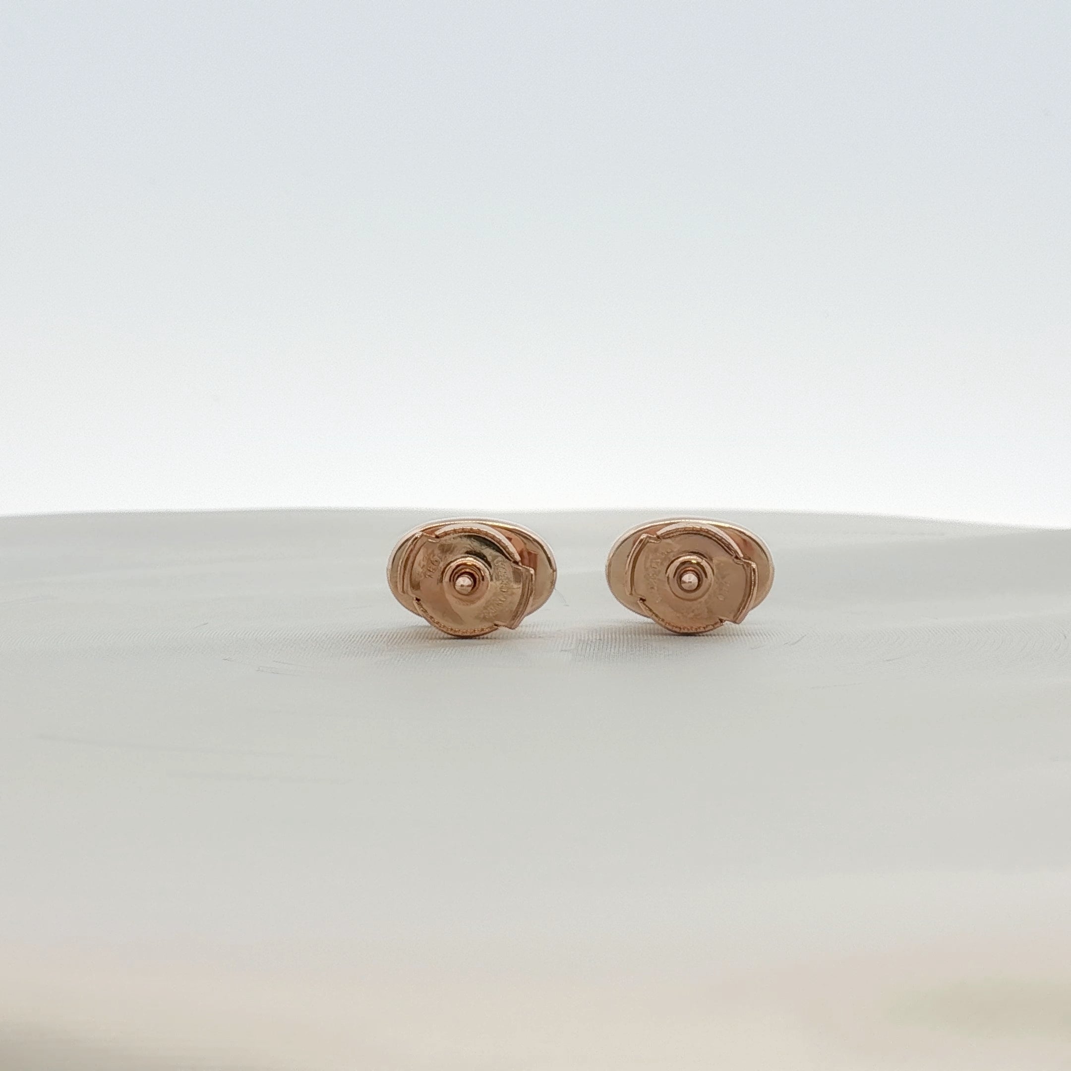 Hermès oval diamond stud earrings in jewelry, showcasing elegant diamond details and sleek metal setting.