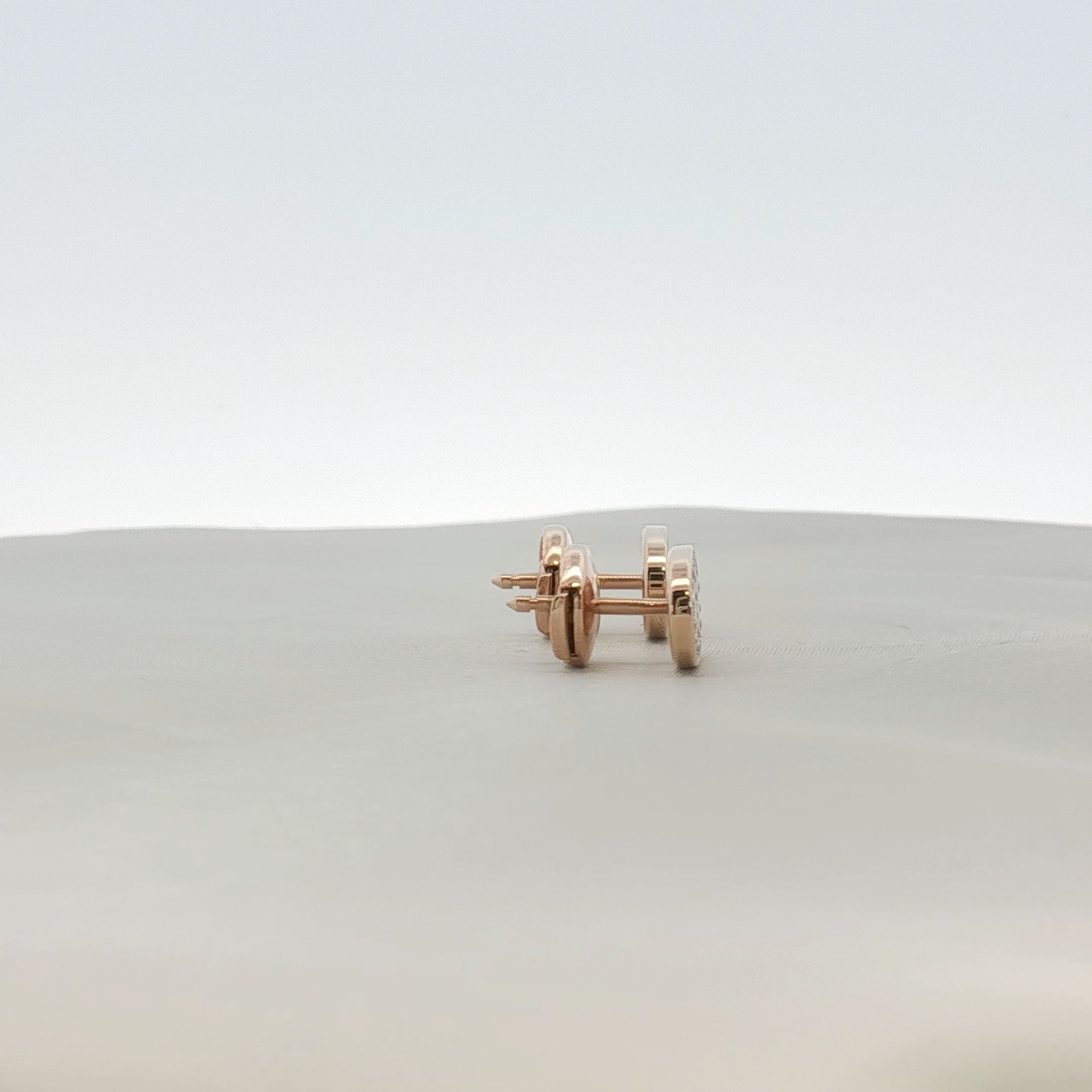 Hermès oval diamond stud earrings in jewelry setting with sparkling diamonds and elegant design.