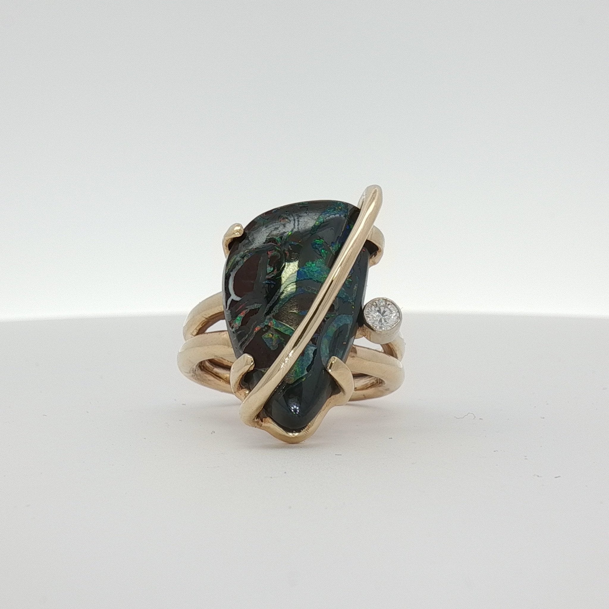 14K yellow gold opal and diamond statement ring featuring a vibrant opal centerpiece with sparkling diamonds from Gold & Beyond.