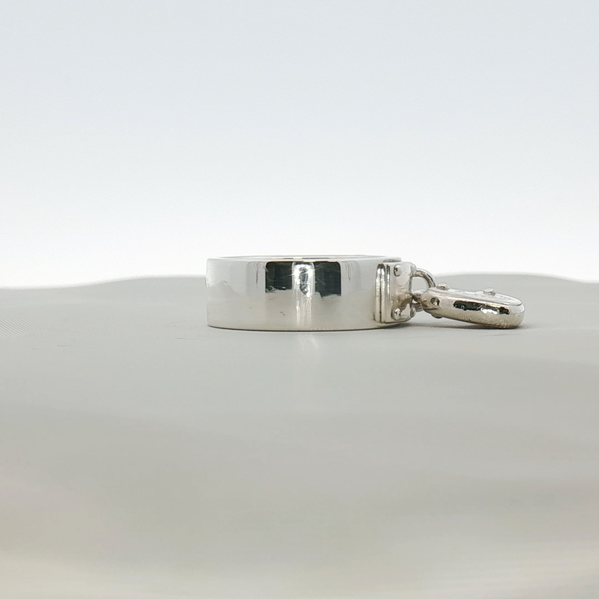 Sterling silver heart-shaped ring by Tiffany & Co. displayed on a jewelry stand, showcasing its elegant design.