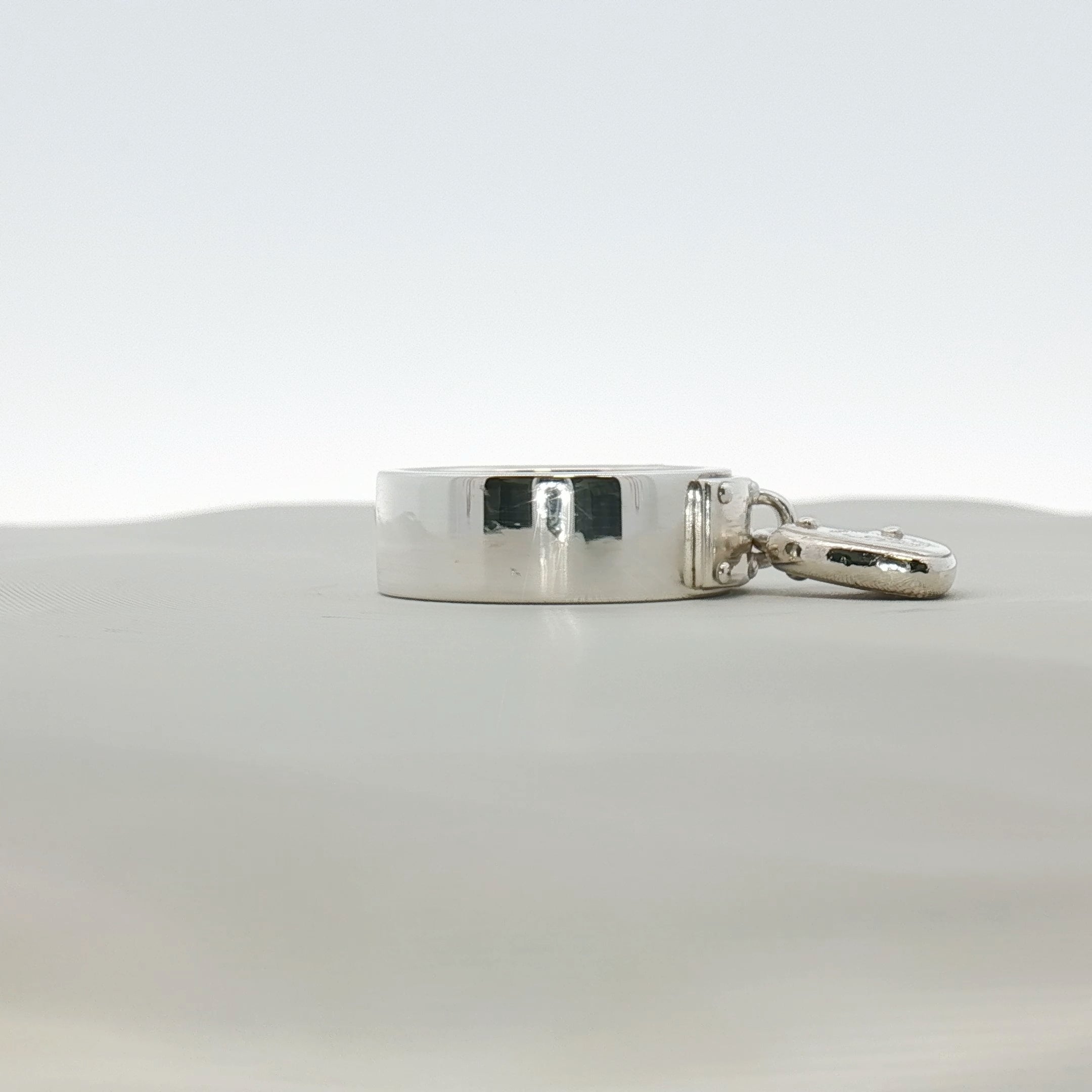 Sterling silver heart-shaped ring by Tiffany & Co. displayed on a jewelry stand, showcasing its elegant design.