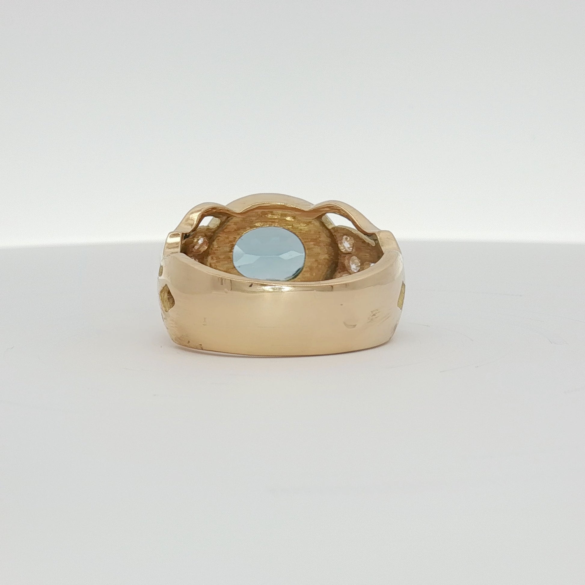 18K yellow gold oval blue gemstone and diamond ring with intricate detailing, crafted by Gold & Beyond.