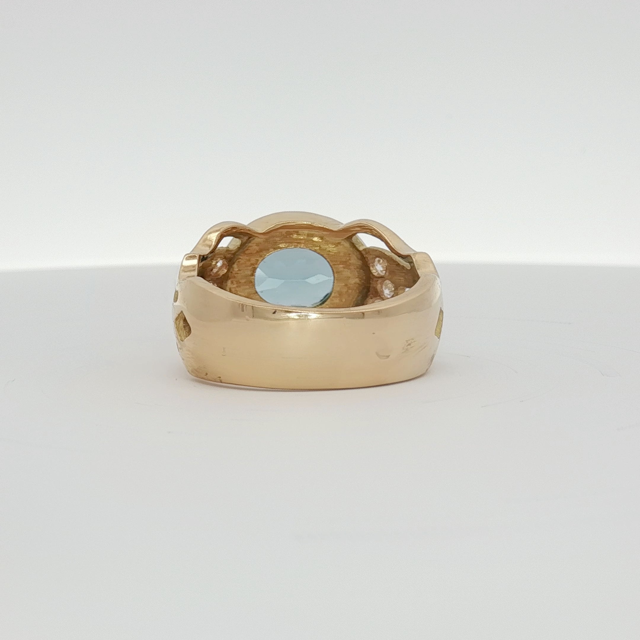 18K yellow gold oval blue gemstone and diamond ring with intricate detailing, crafted by Gold & Beyond.