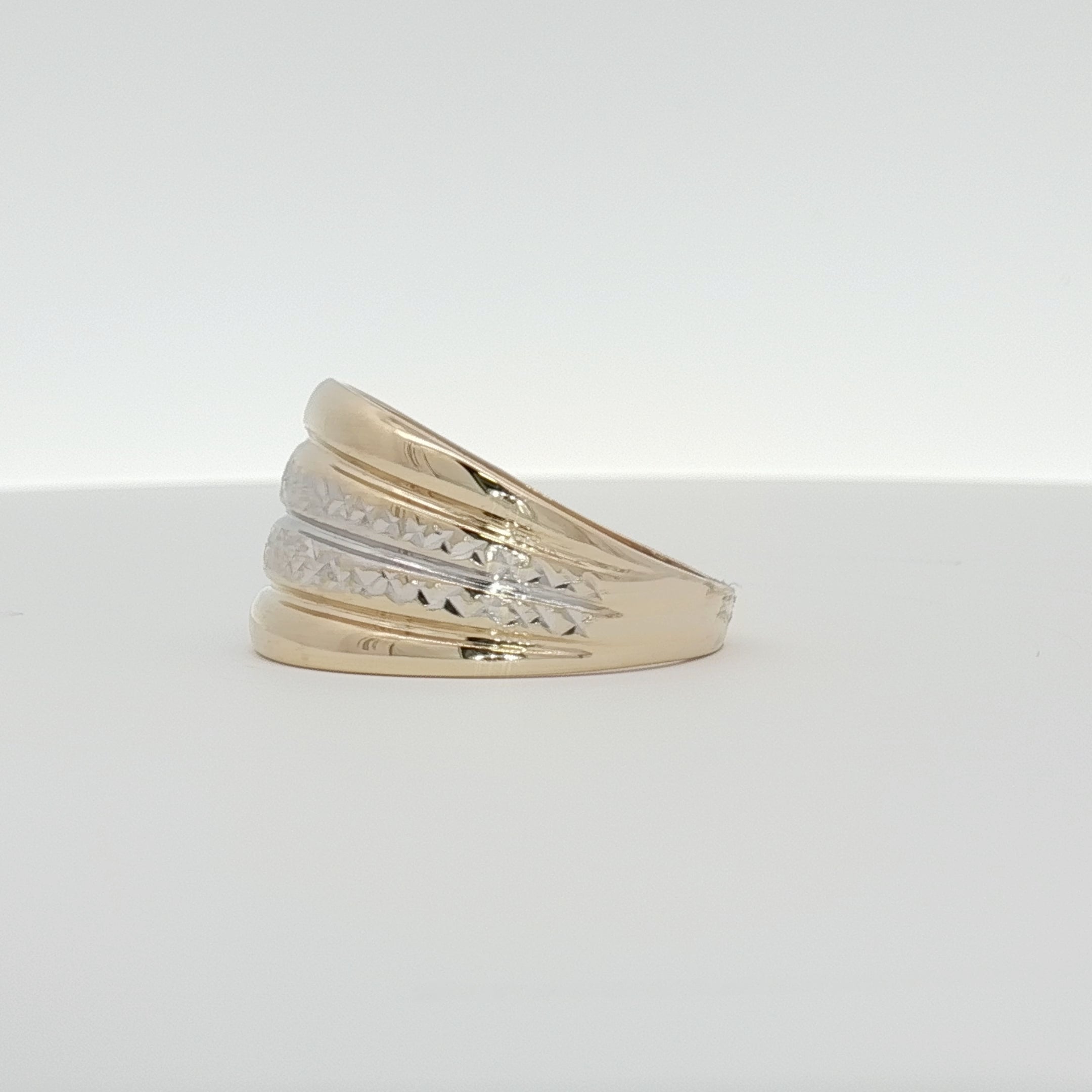 14K gold two-tone ring featuring a polished band and intricate design, showcasing elegant jewelry craftsmanship.