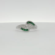 14K white gold emerald and diamond bypass ring featuring a sleek design and sparkling gemstones from Gold & Beyond.