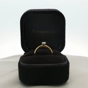 Gold & Beyond Tiffany & Co. classic solitaire diamond jewelry ring with a single sparkling diamond on a sleek band.