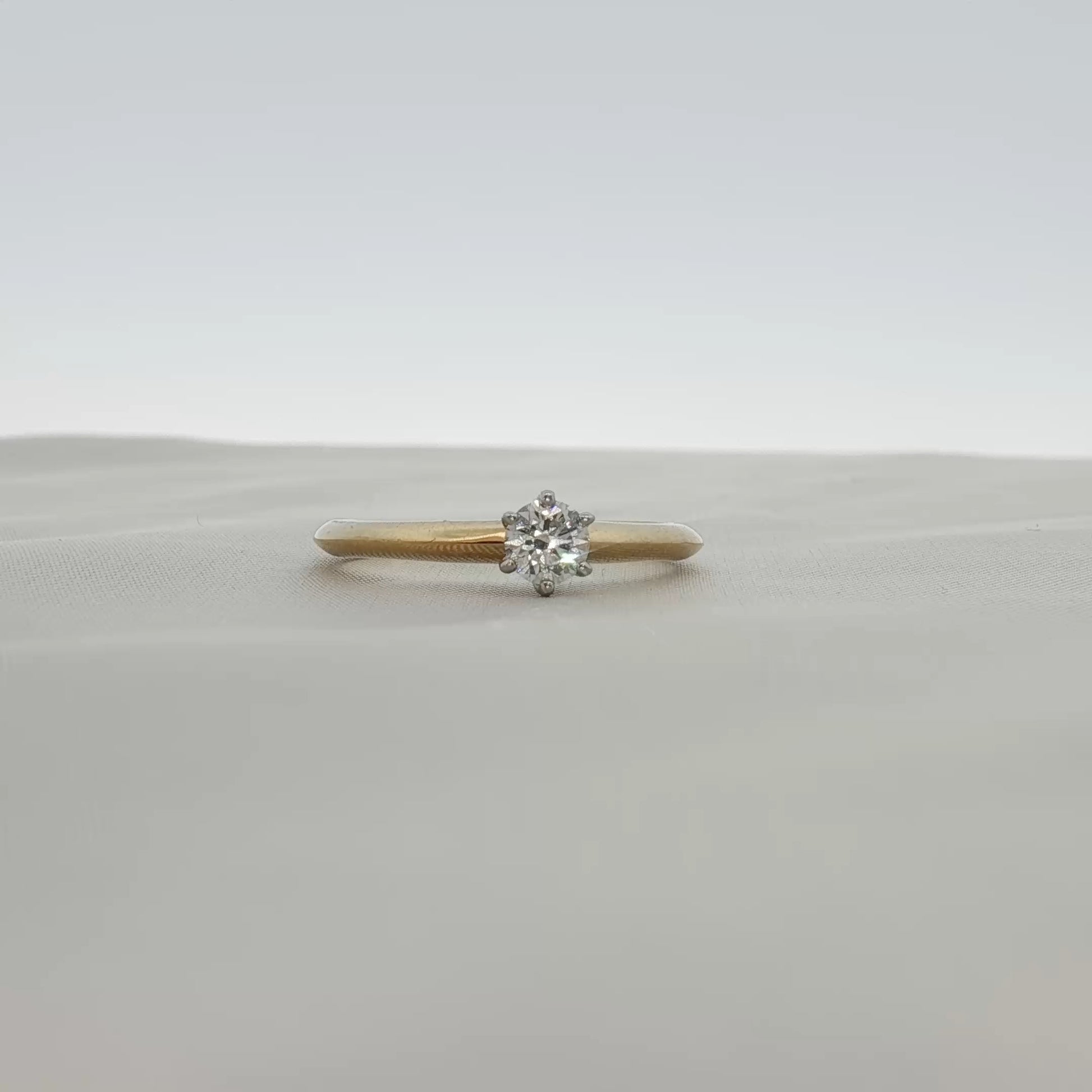 Gold & Beyond Tiffany & Co. classic solitaire diamond ring showcasing a single sparkling diamond on a sleek band