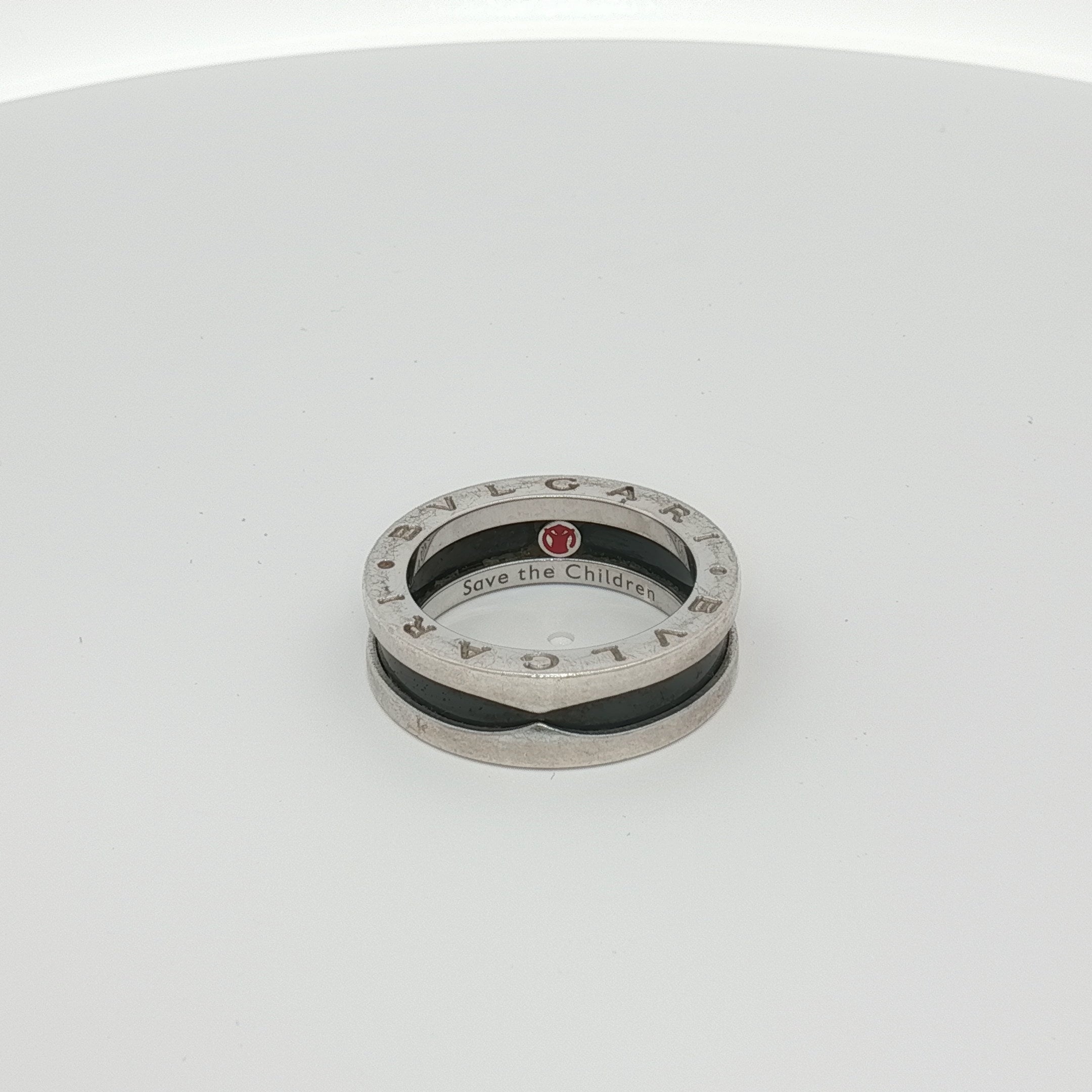 Gold & Beyond Bulgari Save the Children ring, elegant jewelry piece with intricate design and branding details.