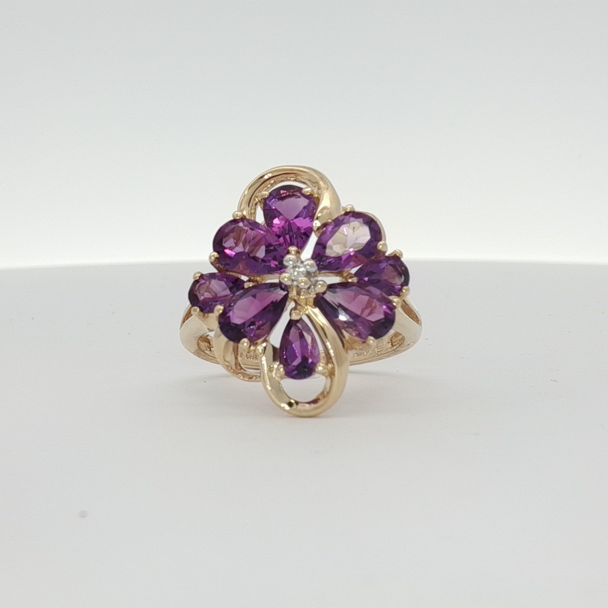Yellow gold amethyst flower ring featuring a detailed floral design, crafted by Gold & Beyond in 10K gold jewelry.