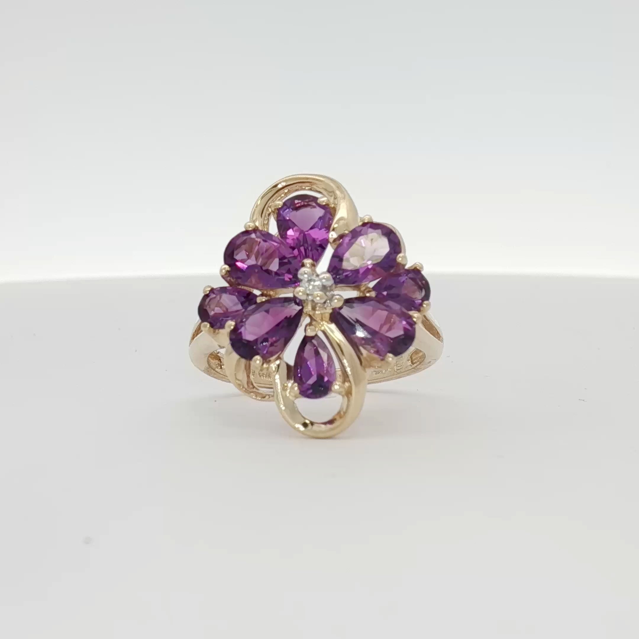 10K yellow gold amethyst flower ring with intricate floral design, showcasing vibrant purple amethyst gemstone and detailed craftsmanship.