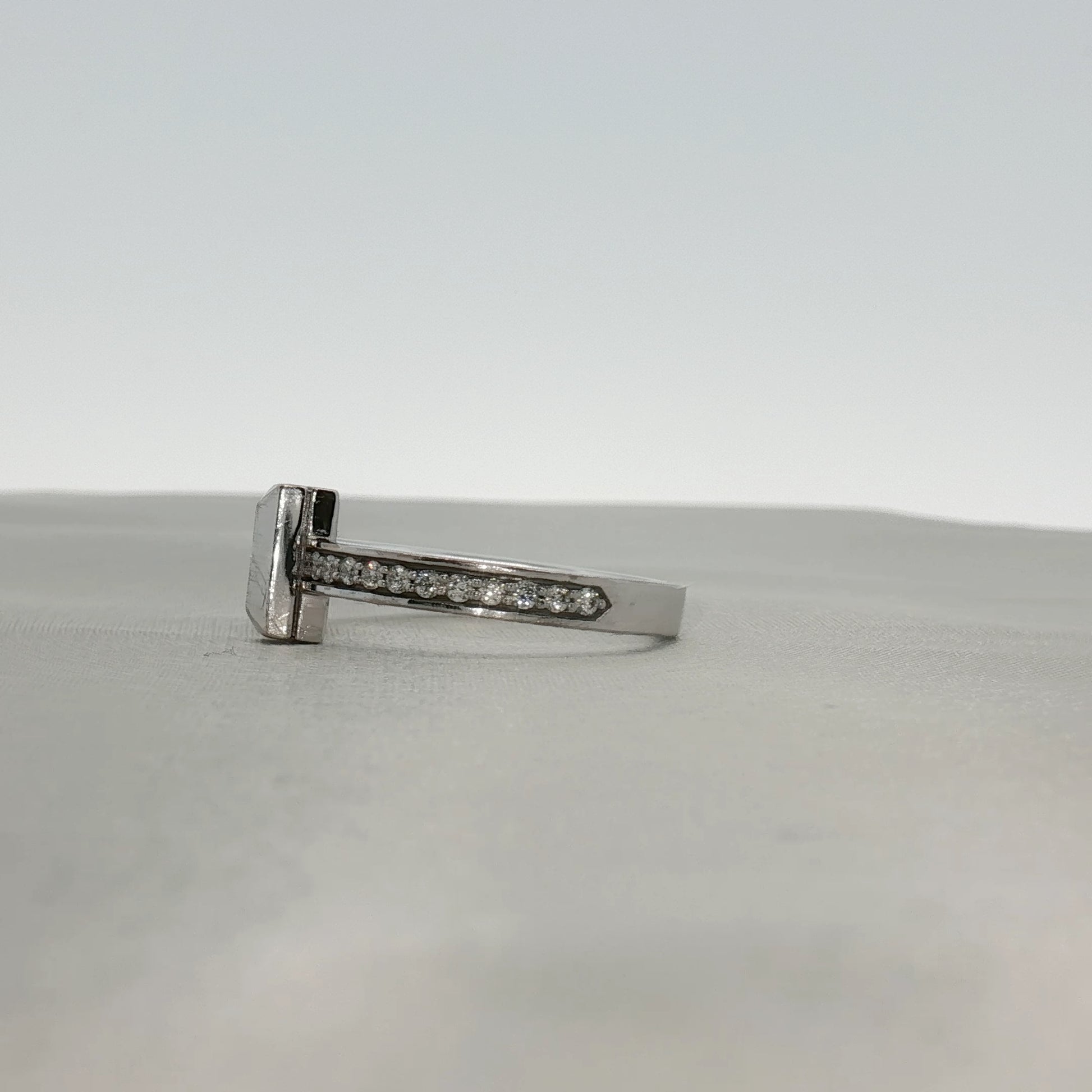 Gold & Beyond Tiffany & Co. Return to Tiffany T diamond ring featuring sterling silver band with engraved logo and sparkling diamonds.