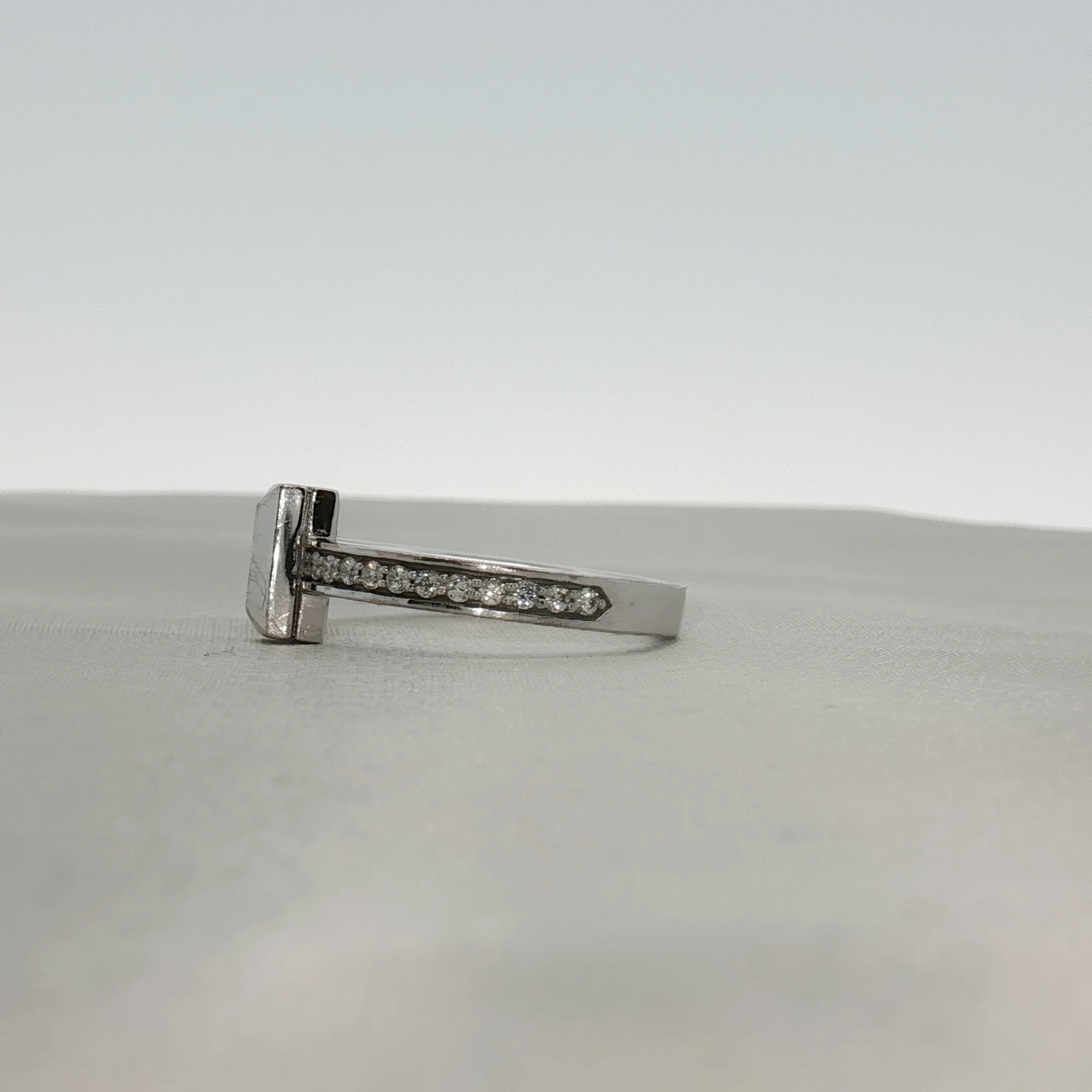Gold & Beyond Tiffany & Co. Return to Tiffany T diamond ring featuring sterling silver band with engraved logo and sparkling diamonds.