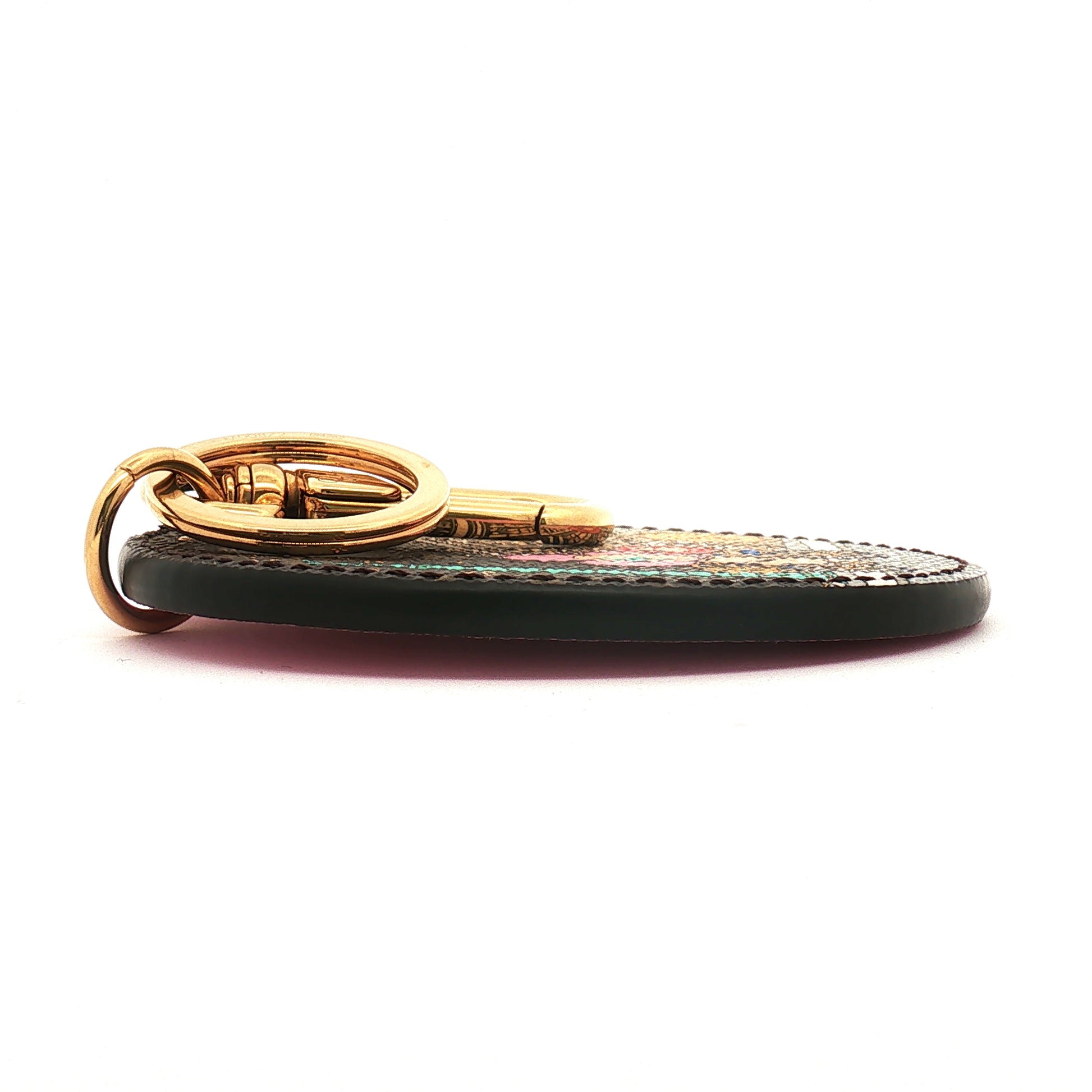 Louis Vuitton Illustre Christmas Paris bag charm and key holder, gold-toned accessories with festive holiday design and branding.