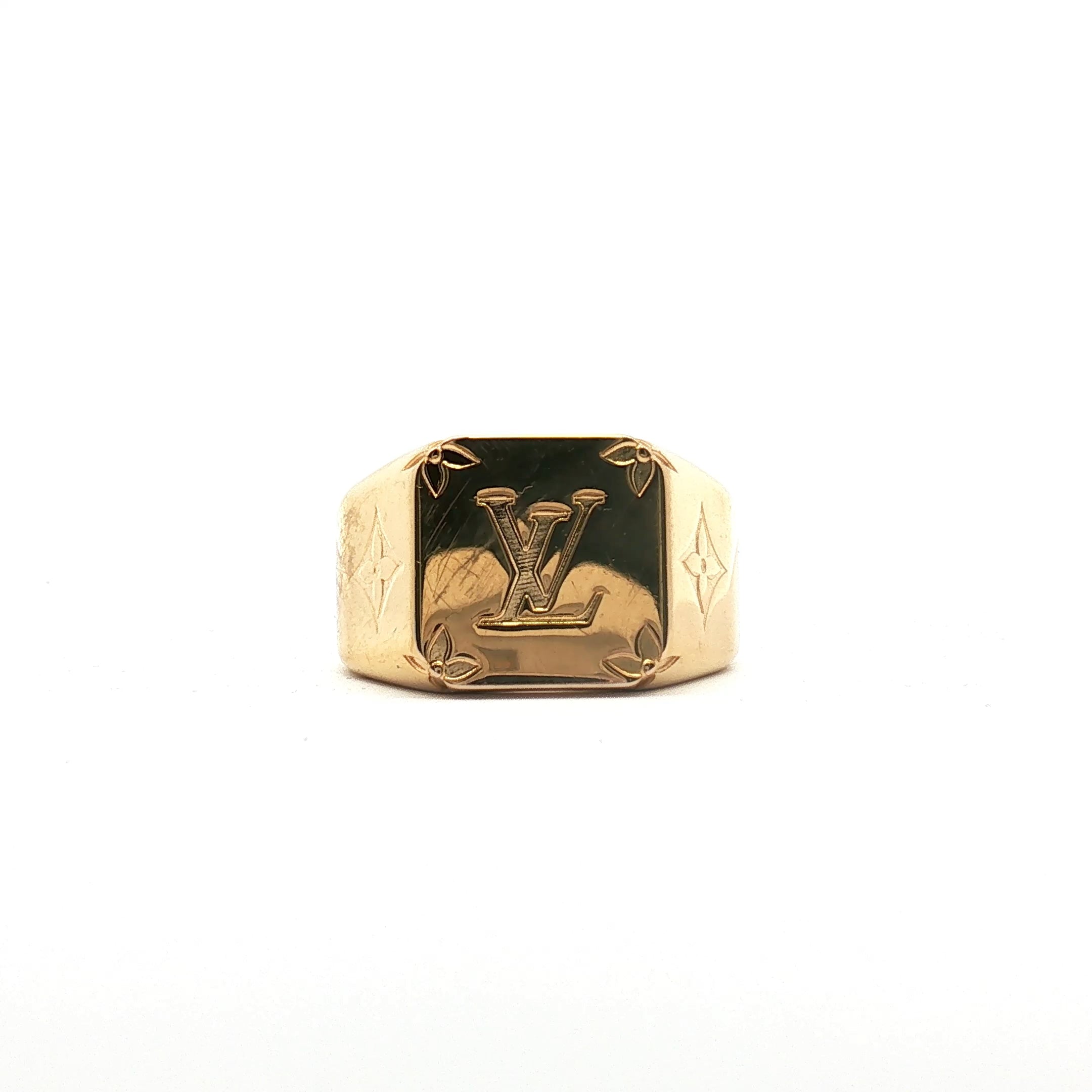 Louis Vuitton gold-tone monogram signet ring showcasing the jewelry's elegant design and brand logo detail.