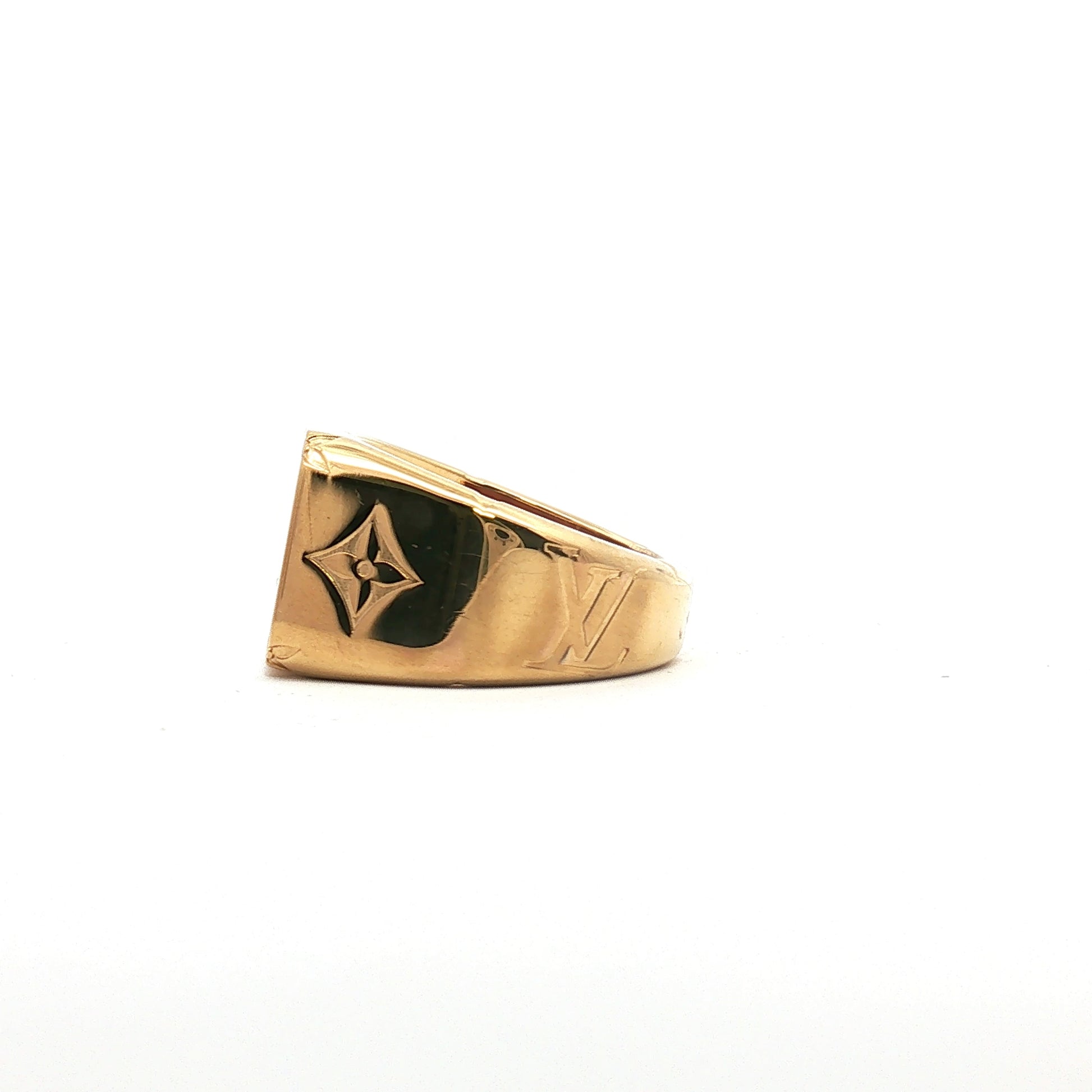 Louis Vuitton gold-tone monogram signet ring, jewelry piece with LV logo design, on a neutral background.