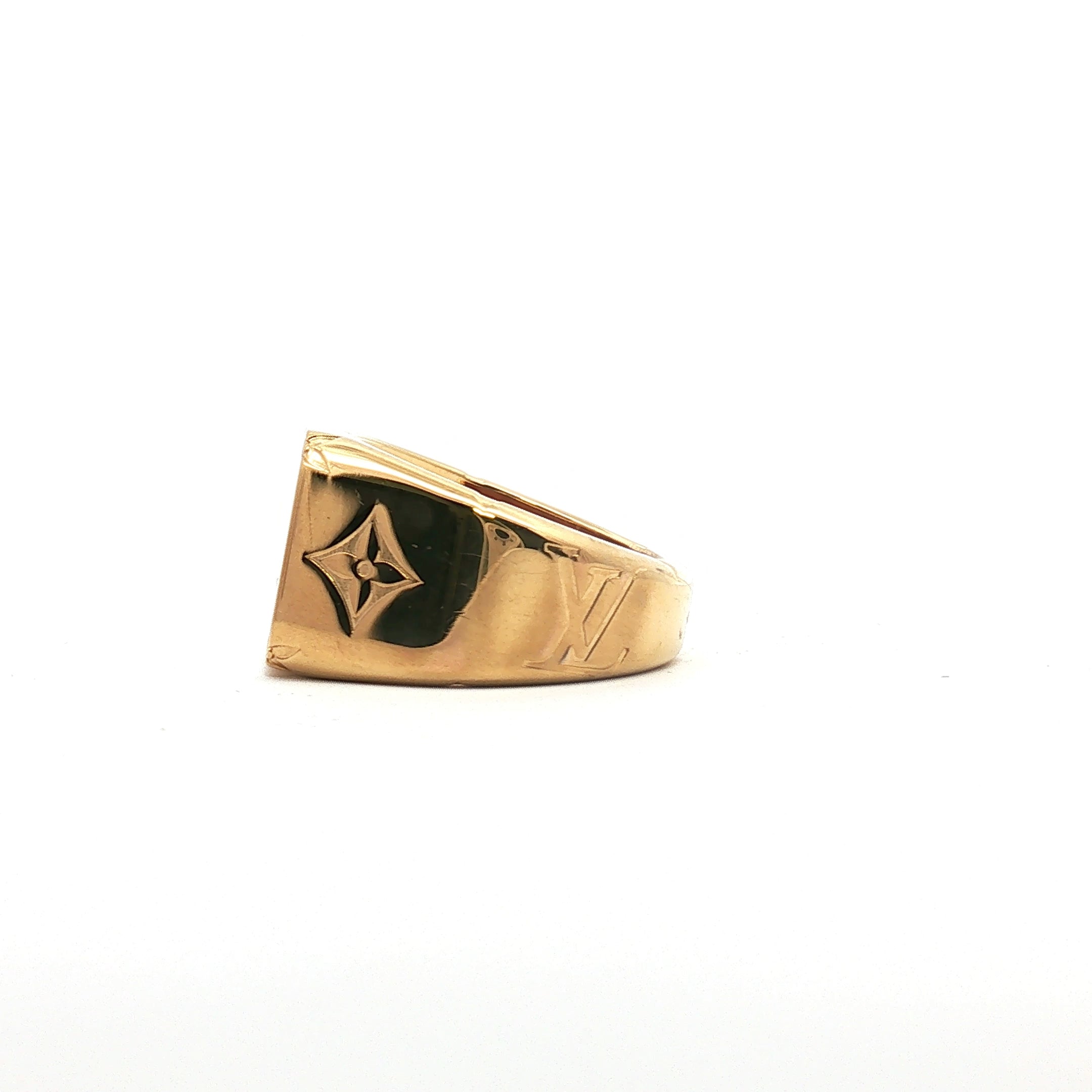 Louis Vuitton gold-tone monogram signet ring, jewelry piece with LV logo design, on a neutral background.