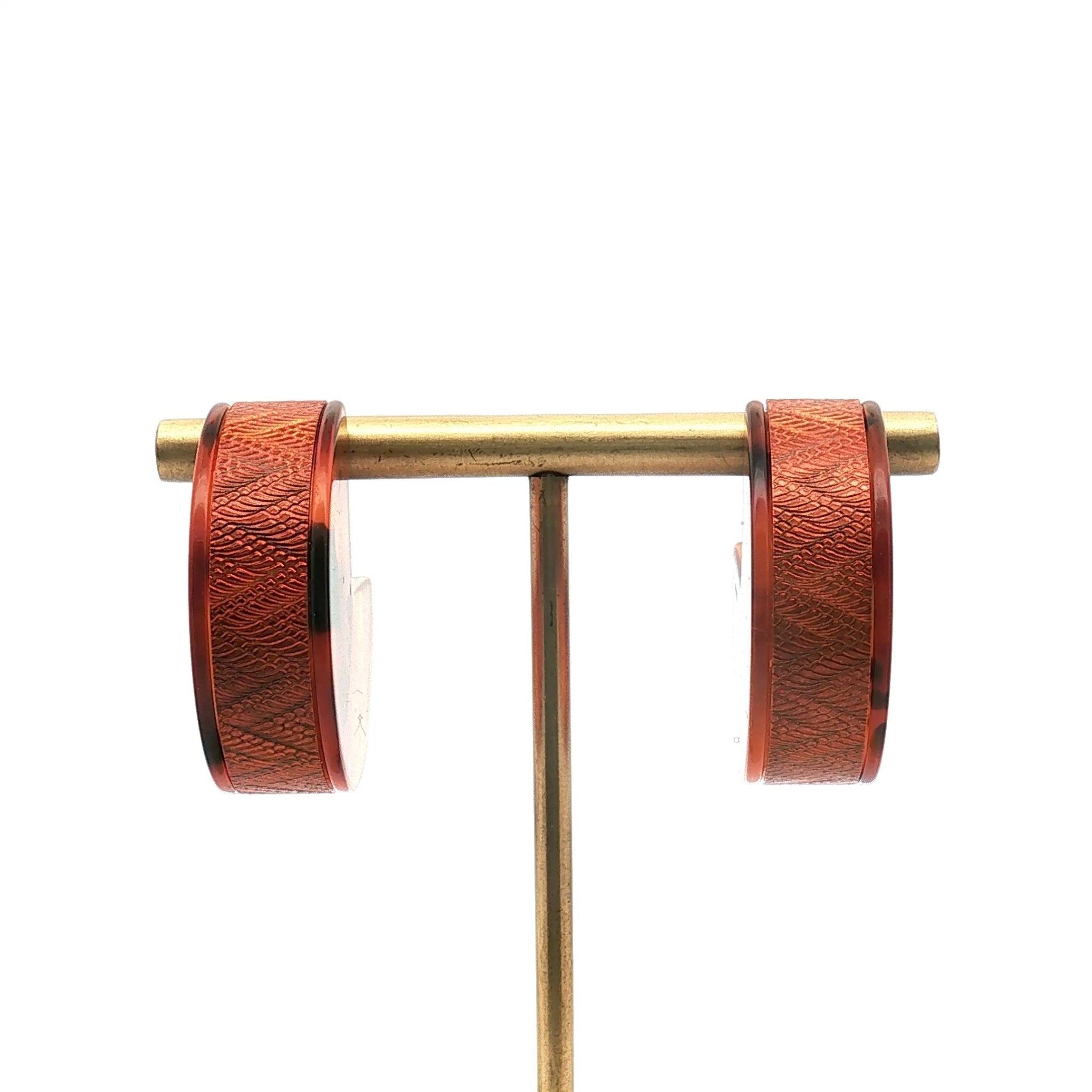 Louis Vuitton tortoise resin hoop earrings, stylish jewelry with gold accents, featuring a classic round hoop design.