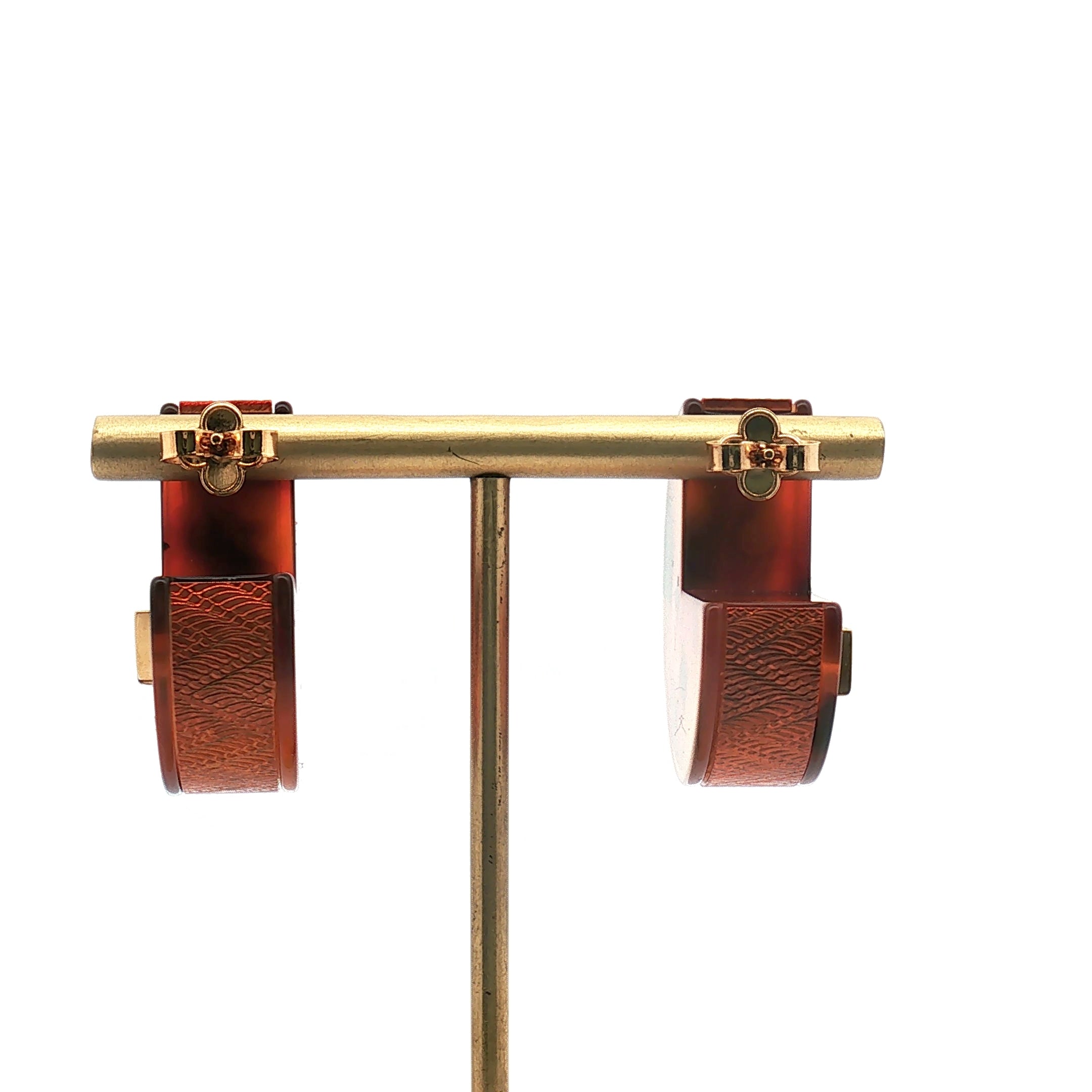 Louis Vuitton tortoise resin hoop earrings, jewelry with gold accents, featuring smooth, rounded hoop design and tortoise pattern.