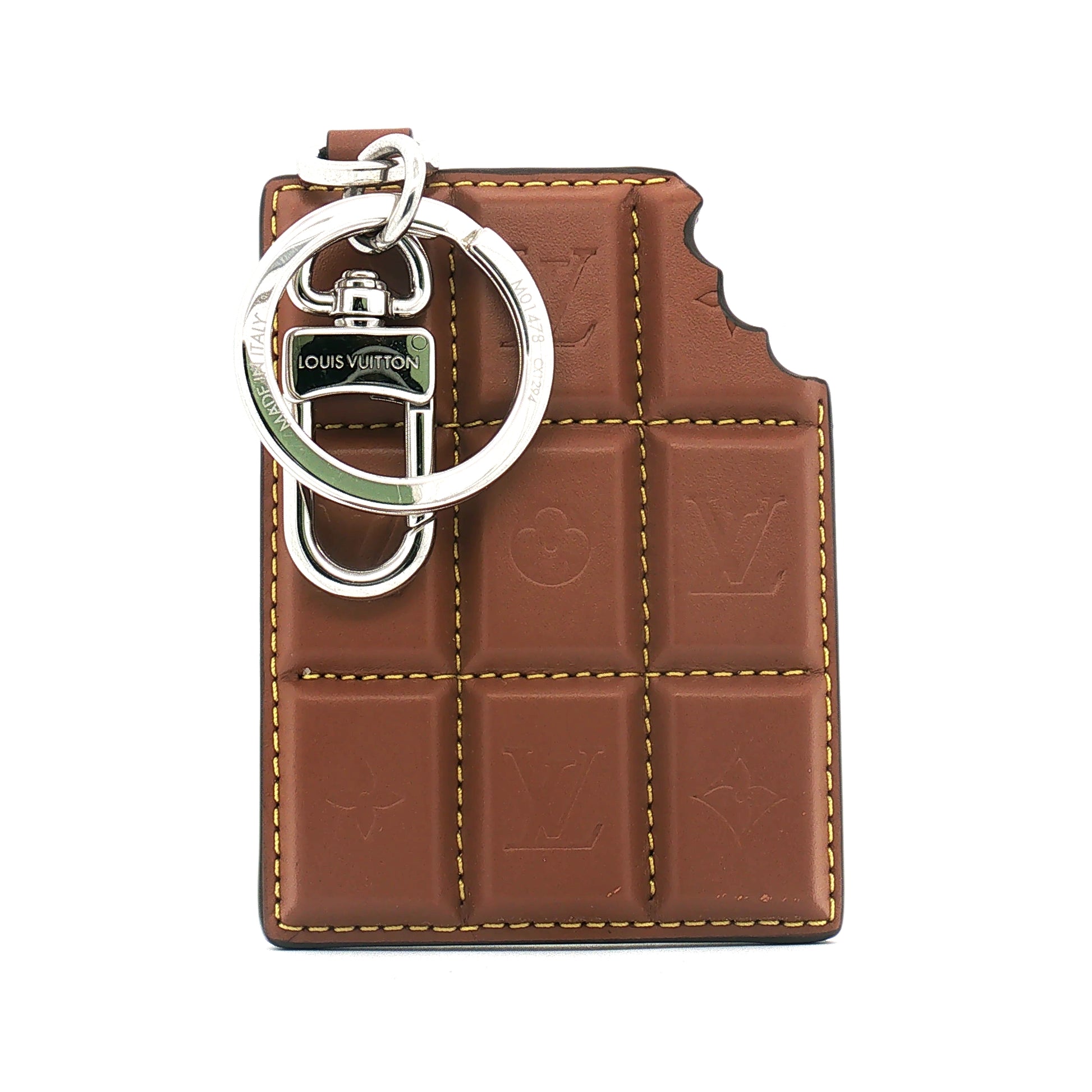 Louis Vuitton chocolate bar bag charm and key holder accessory with gold accents, featuring branded details and a stylish design.