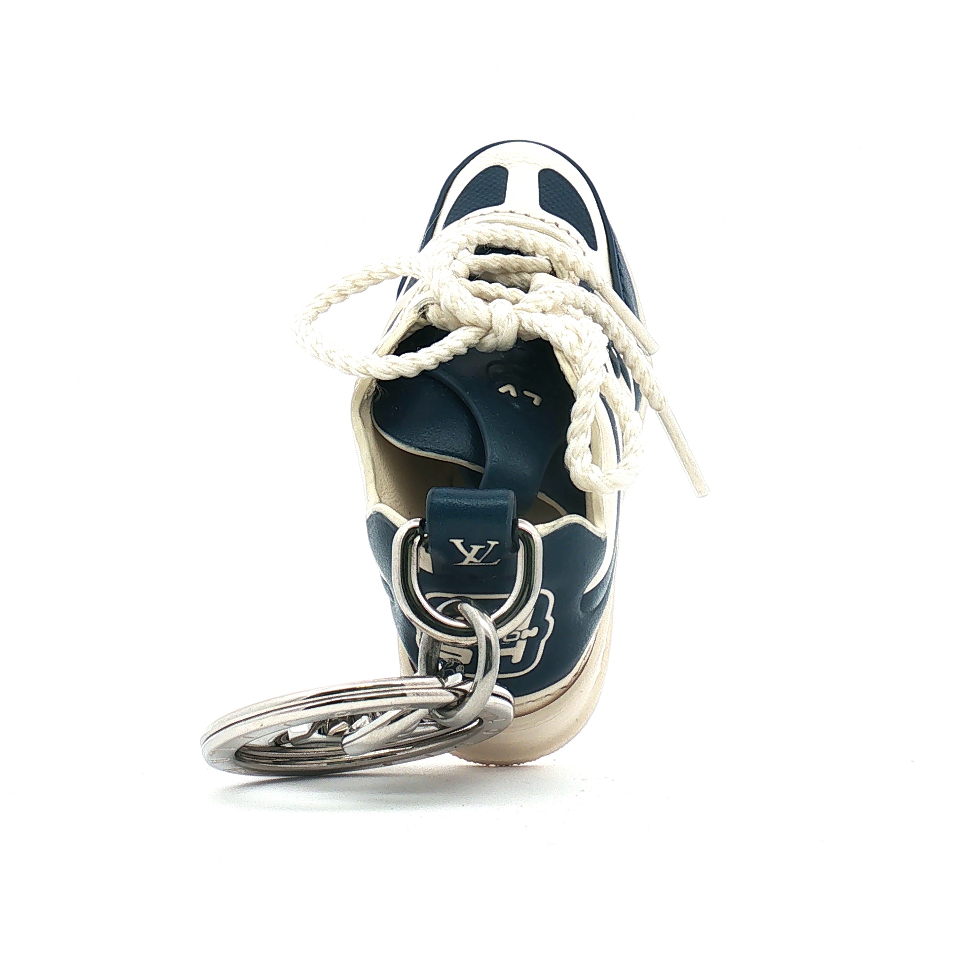 Louis Vuitton LV Trainer sneaker-shaped bag charm and key holder, gold and beyond accessories with detailed design.