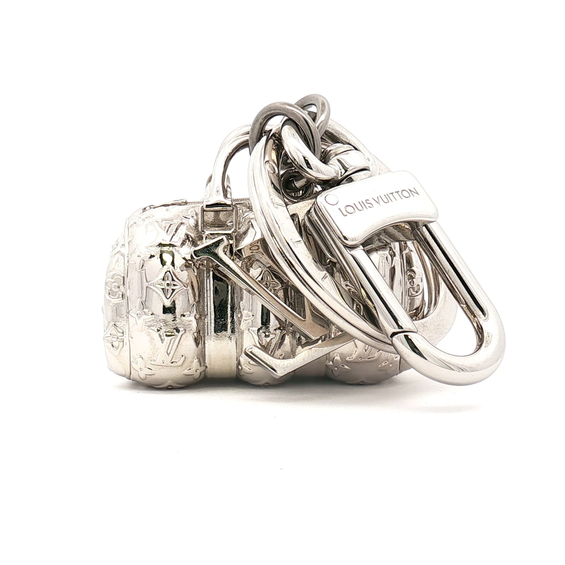 Gold & Beyond Louis Vuitton Keepall bag charm accessory with gold-tone hardware and branded details, designed to enhance luxury luggage.