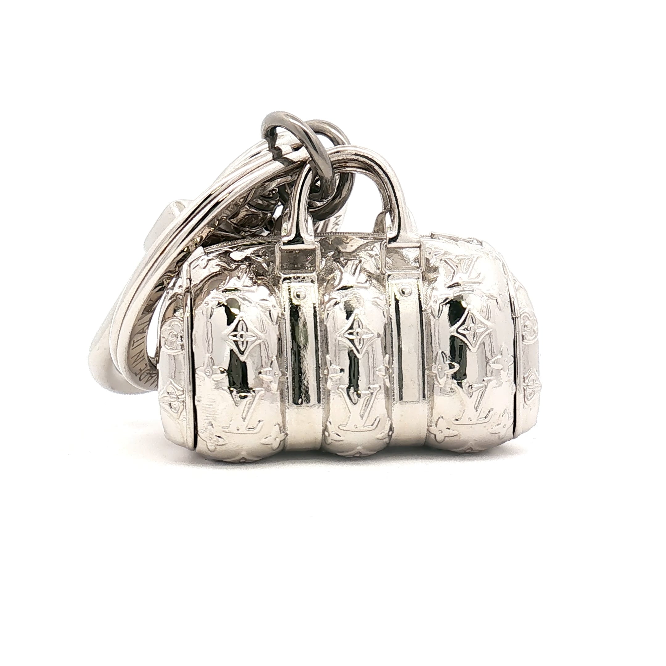 Louis Vuitton Keepall bag charm by Gold & Beyond, featuring a stylish accessory with gold-tone details and branded logo accents.