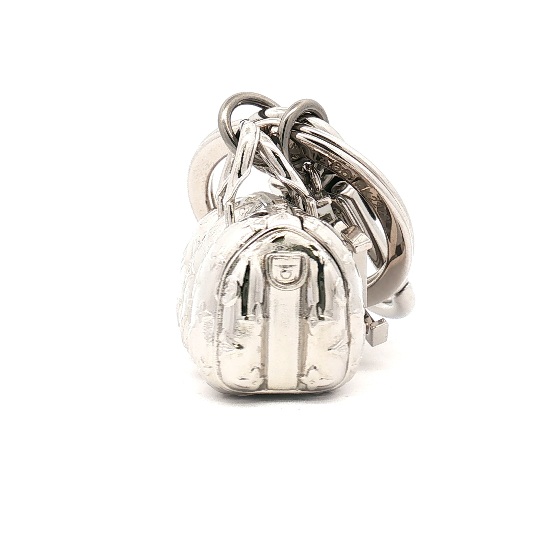 Louis Vuitton Keepall bag charm accessory with gold accents, featuring a stylish, high-quality design for luxury luggage embellishment.