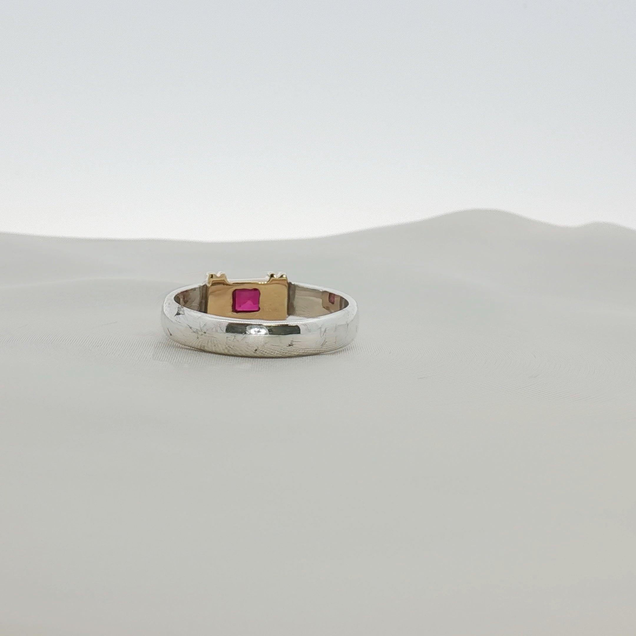 Tiffany & Co. two-tone sterling silver and 18K gold ruby ring with a polished band and vibrant red ruby gemstone.