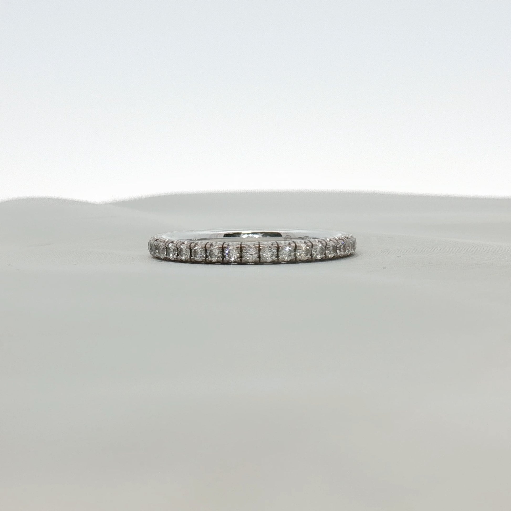 Cartier Love Eternity Diamond Band Ring featuring a gold band with sparkling diamonds, elegant jewelry design.