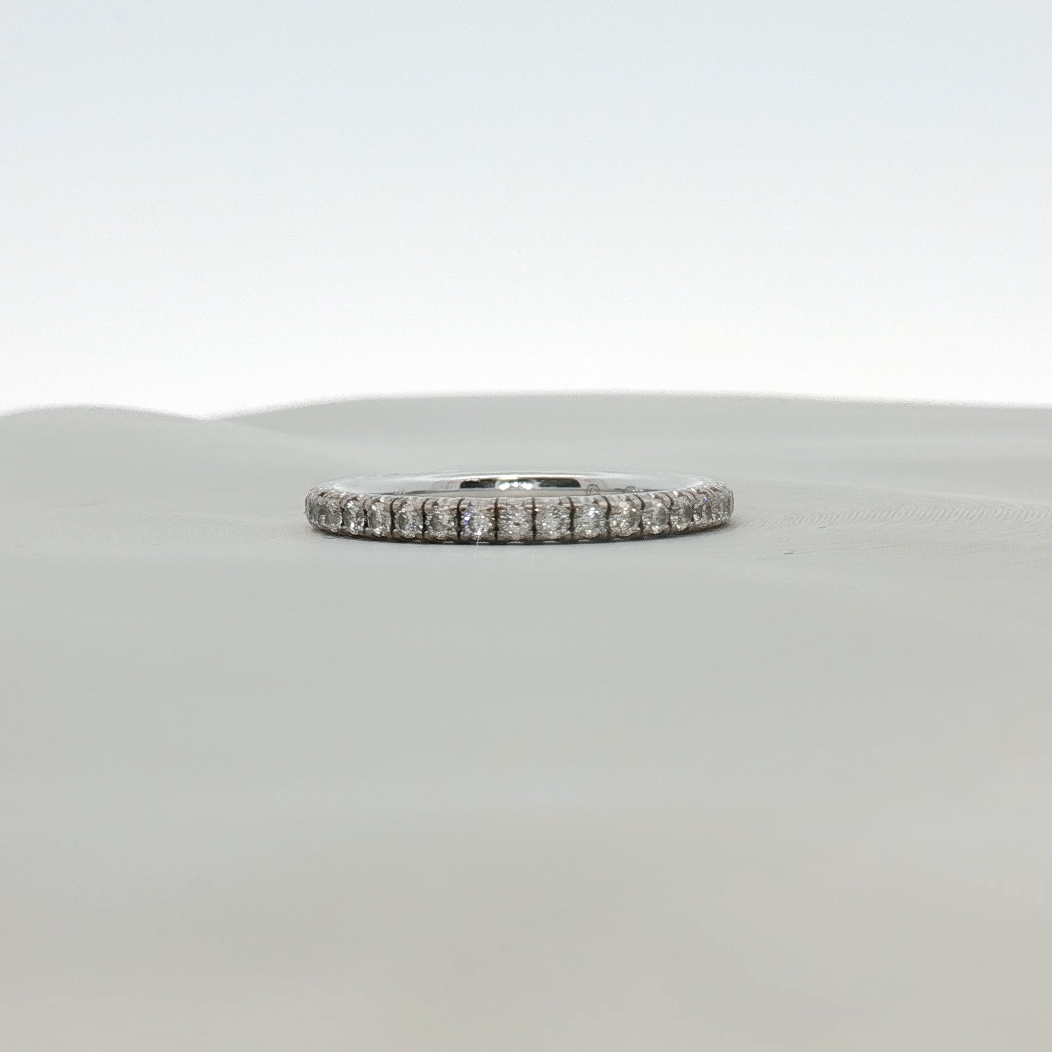 Cartier Love Eternity Diamond Band Ring featuring a gold band with sparkling diamonds, elegant jewelry design.