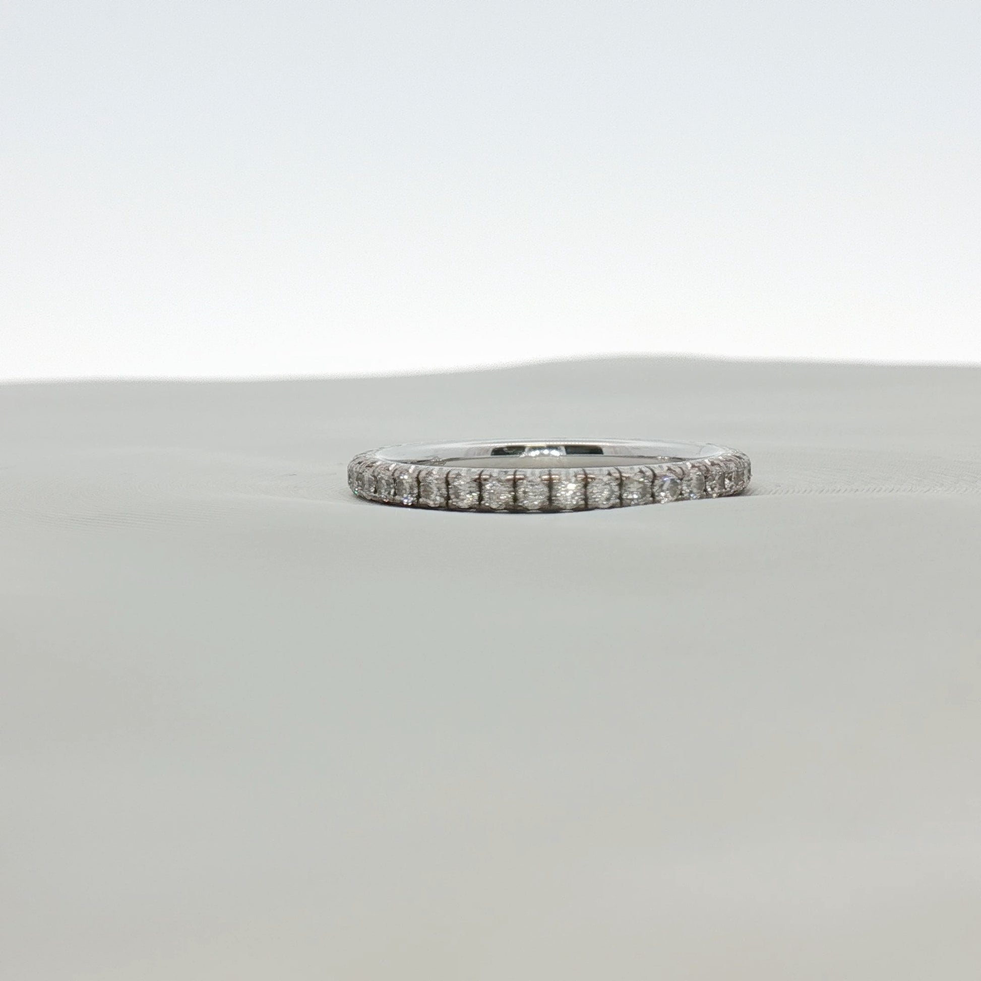 Cartier Love Eternity Diamond Band Ring featuring a gold band with sparkling diamonds, showcasing a luxurious jewelry design.