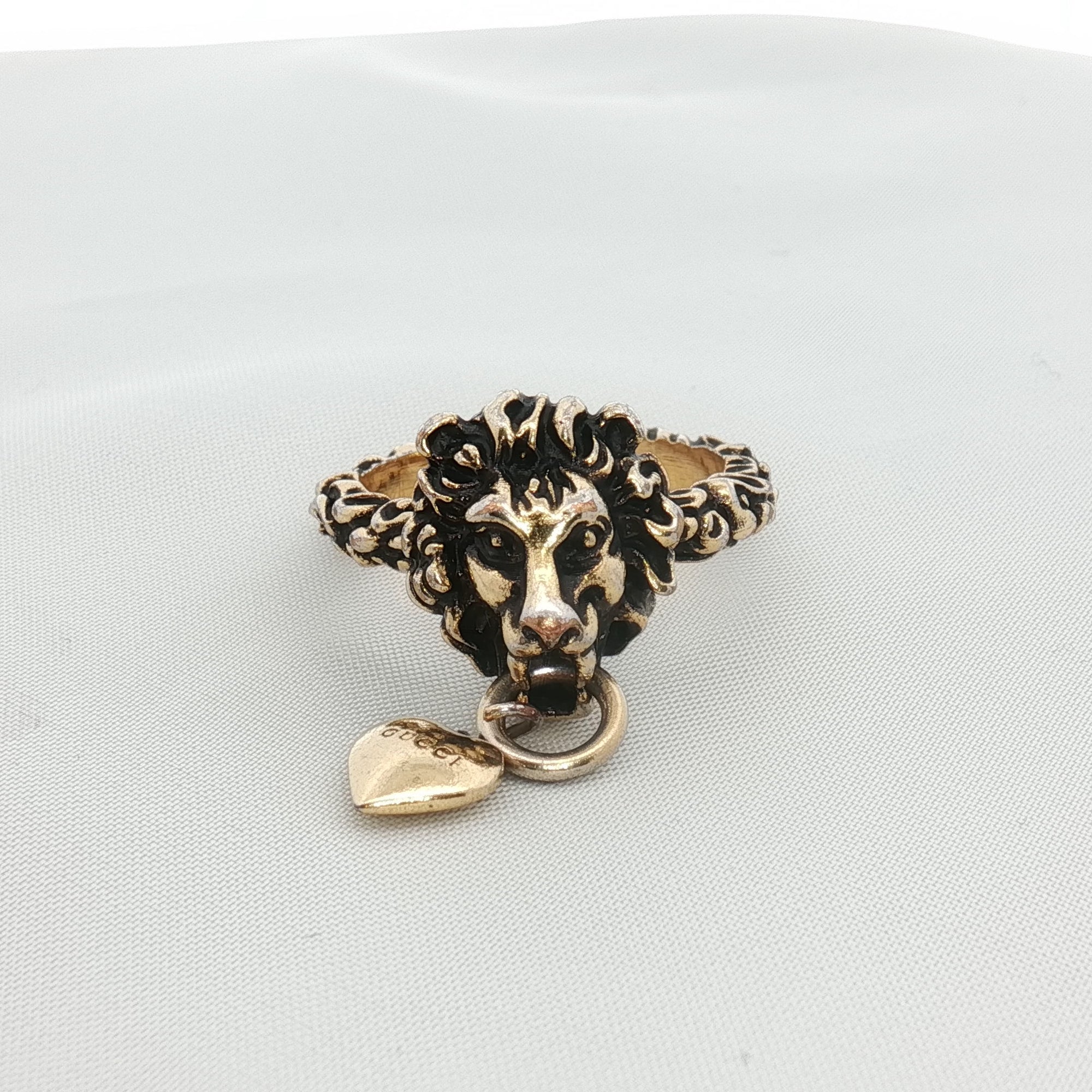 Gold & Beyond Gucci Lion Head with Heart jewelry ring featuring a lion and heart design in gold finish.