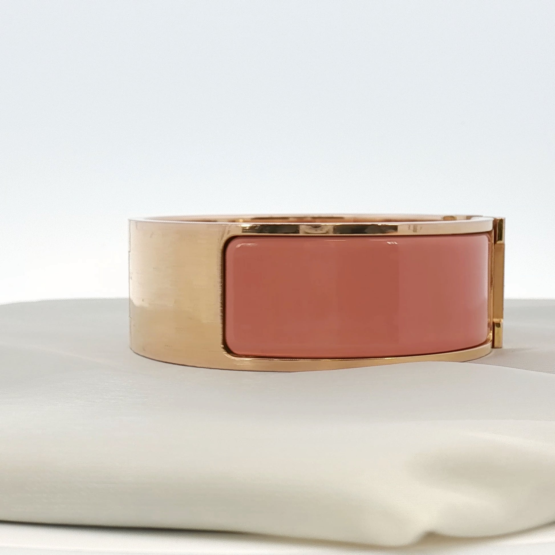 Hermès Wide H bracelet in gold jewelry with a sleek, modern design, featuring the iconic H logo and polished finish.