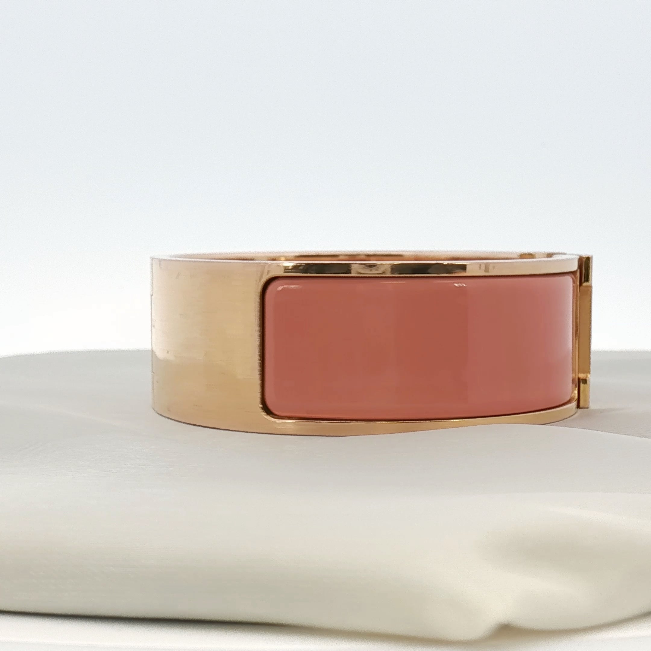 Hermès Wide H bracelet in gold jewelry with a sleek, modern design, featuring the iconic H logo and polished finish.