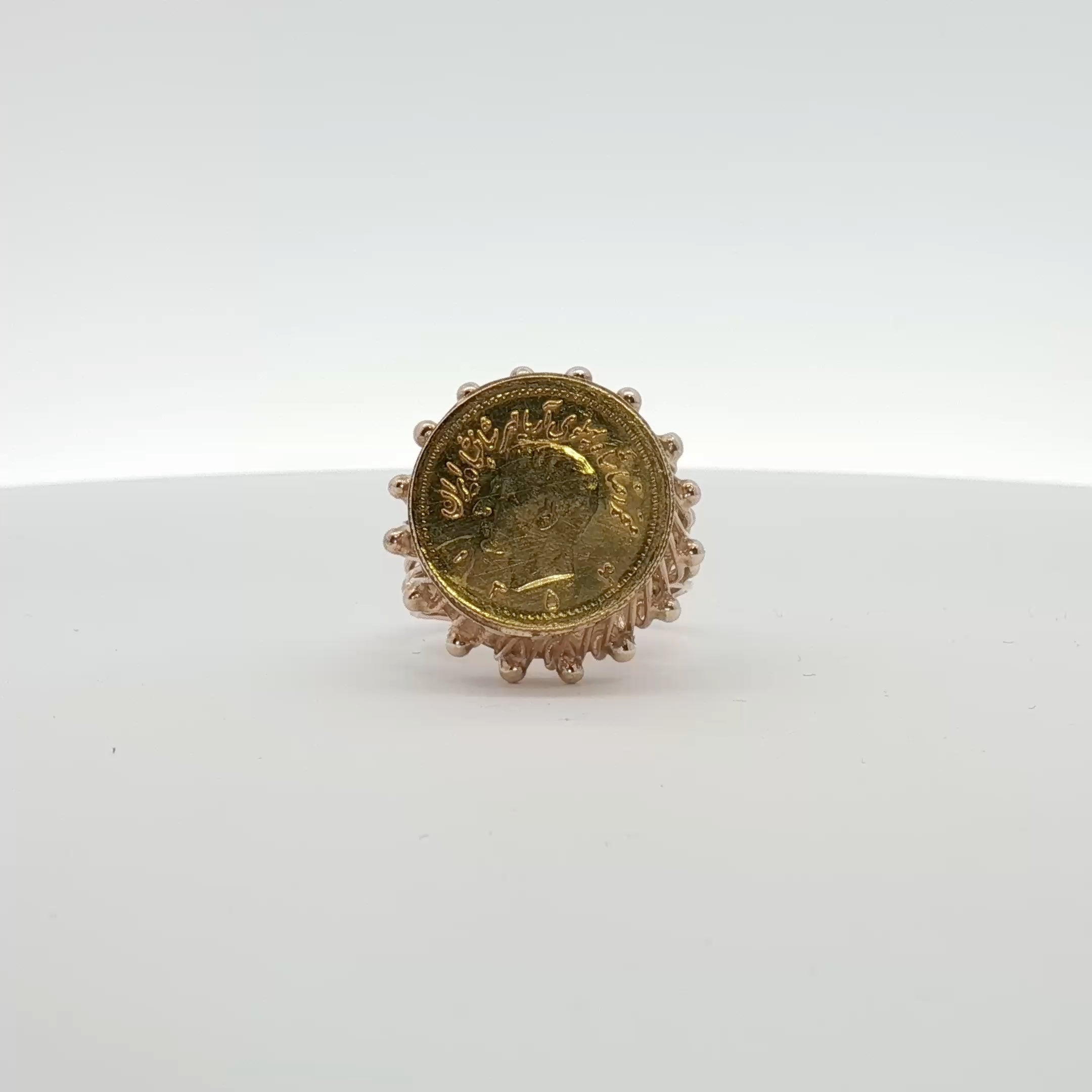 18K yellow gold coin ring from Gold & Beyond with detailed coin design, showcasing elegant jewelry craftsmanship.