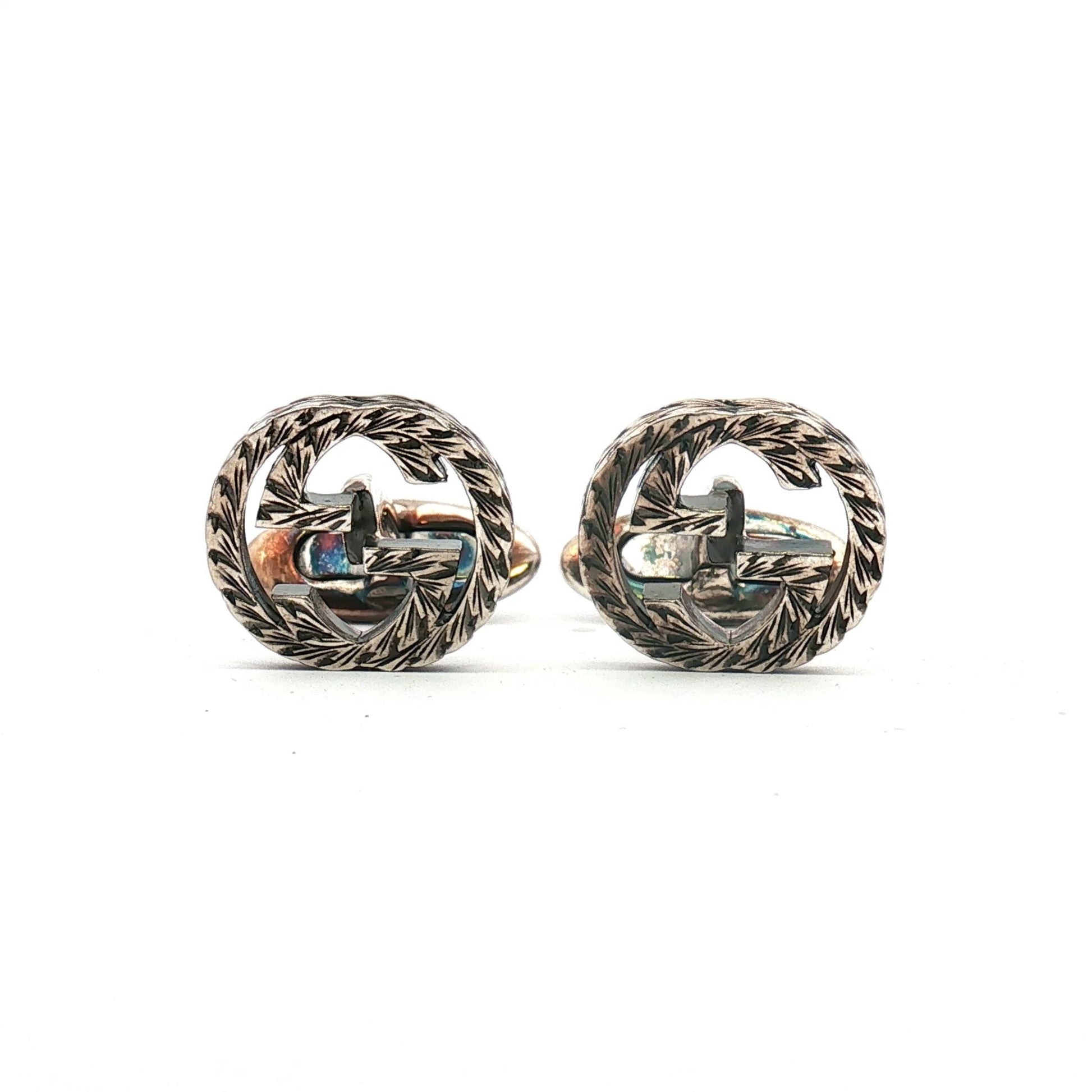 Gucci sterling silver interlocking G cufflinks, elegant jewelry accessory with polished finish and detailed brand logo design.