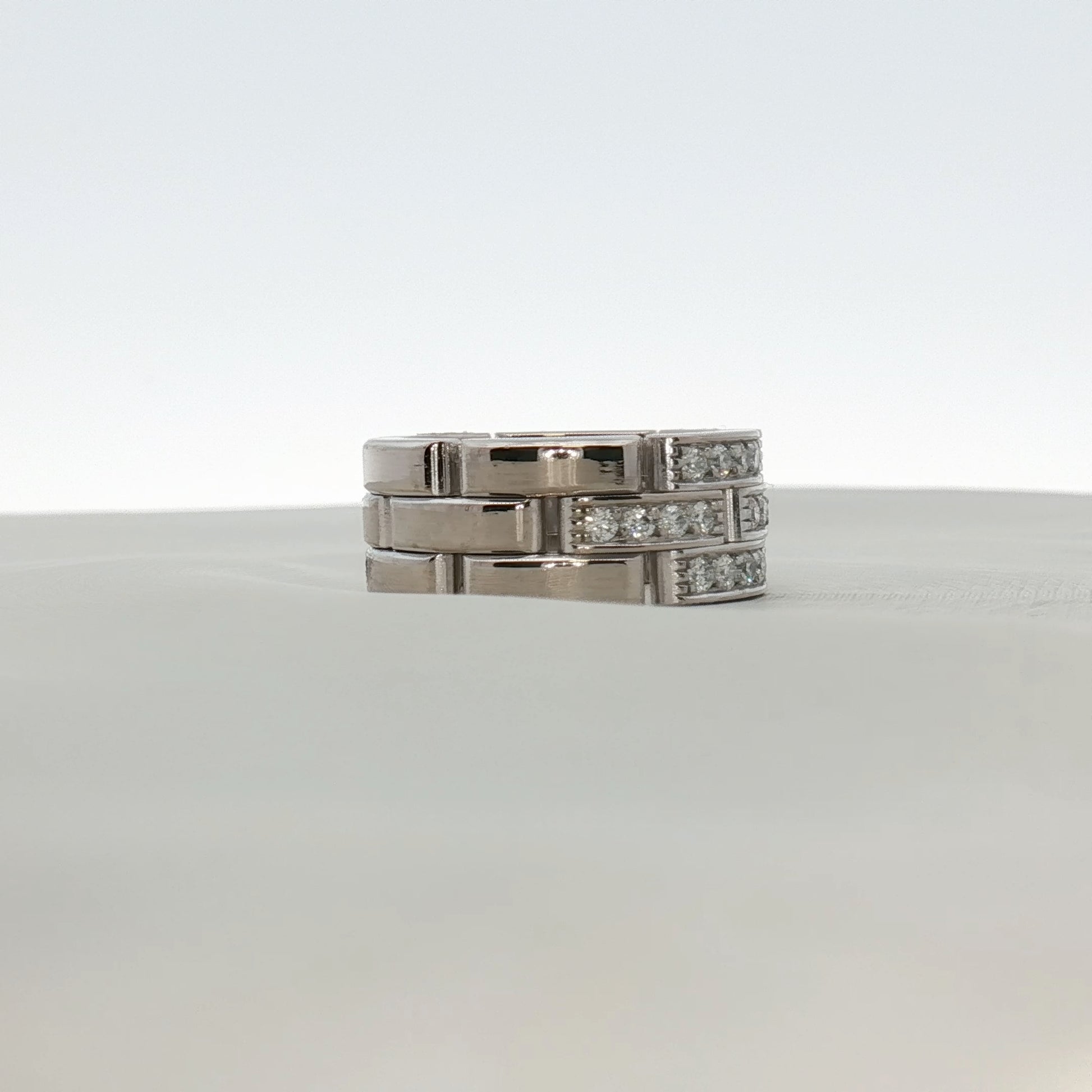 Cartier Maillon diamond ring featuring gold jewelry with intricate chain links and sparkling diamond accents.