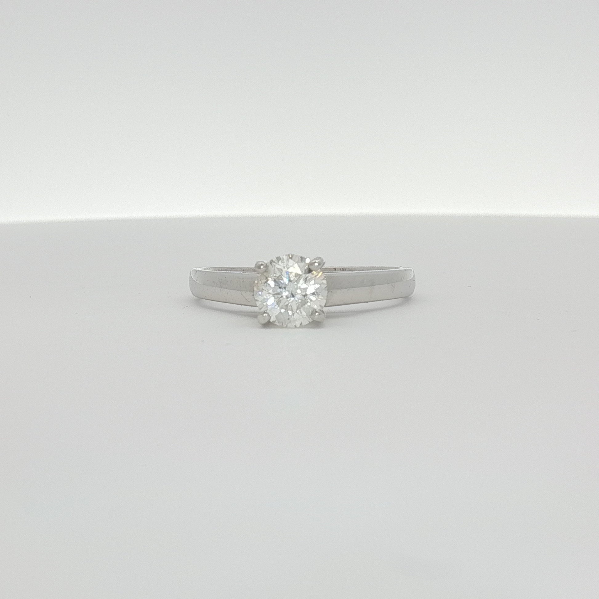 14K white gold diamond solitaire ring featuring a sparkling central diamond and a sleek band, crafted by Gold & Beyond.