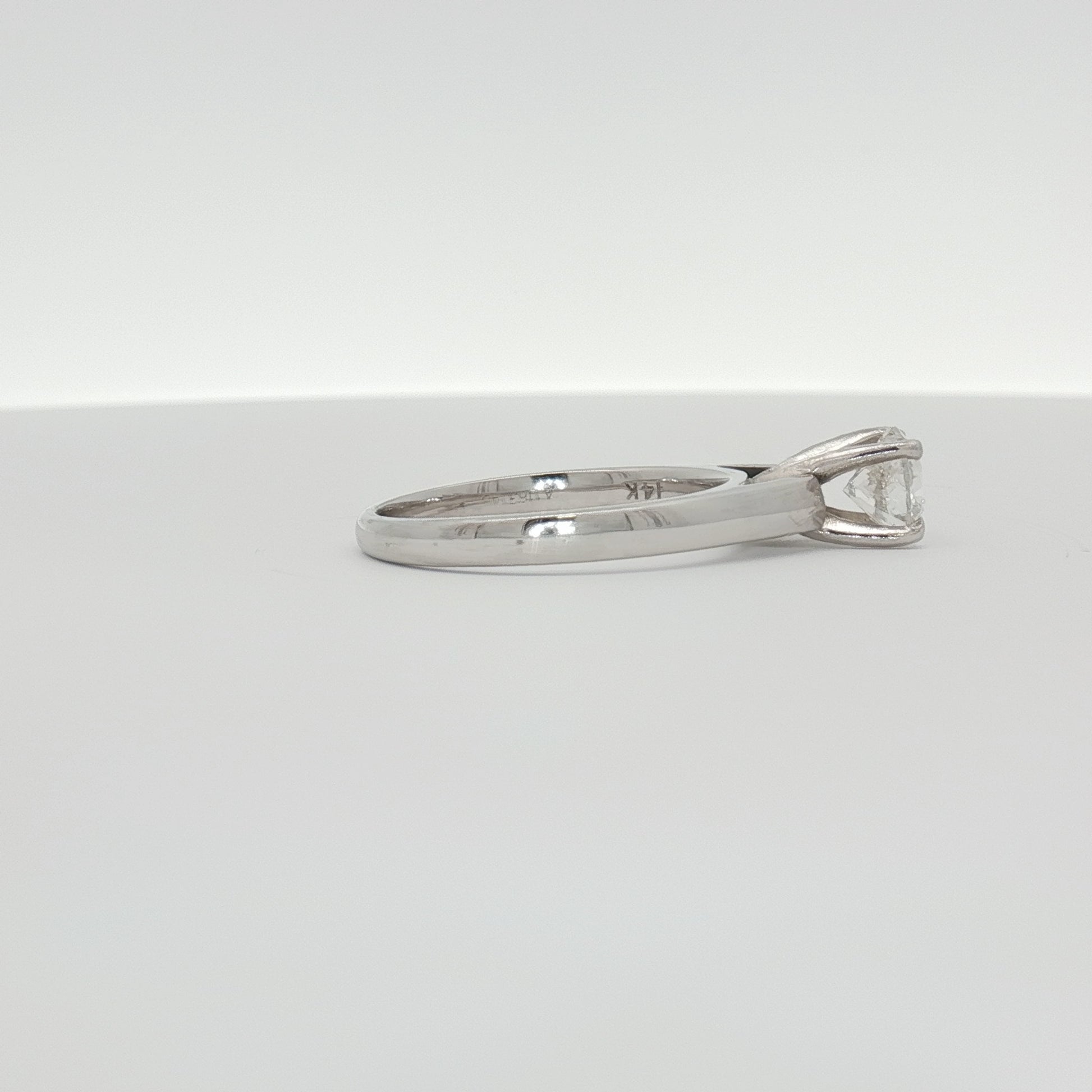 14K white gold diamond solitaire ring with a single sparkling diamond, elegant jewelry piece from Gold & Beyond