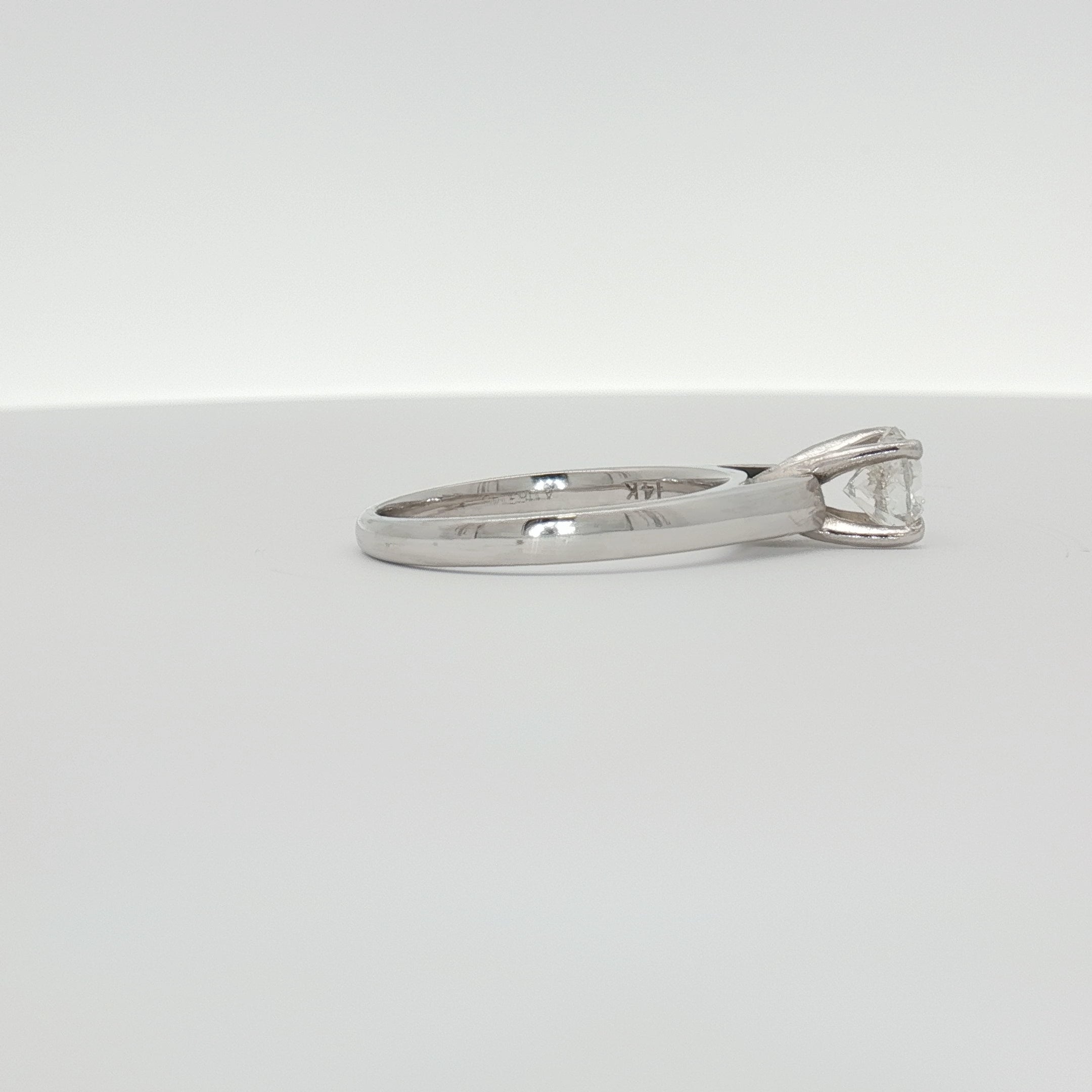 14K white gold diamond solitaire ring with a single sparkling diamond, elegant jewelry piece from Gold & Beyond