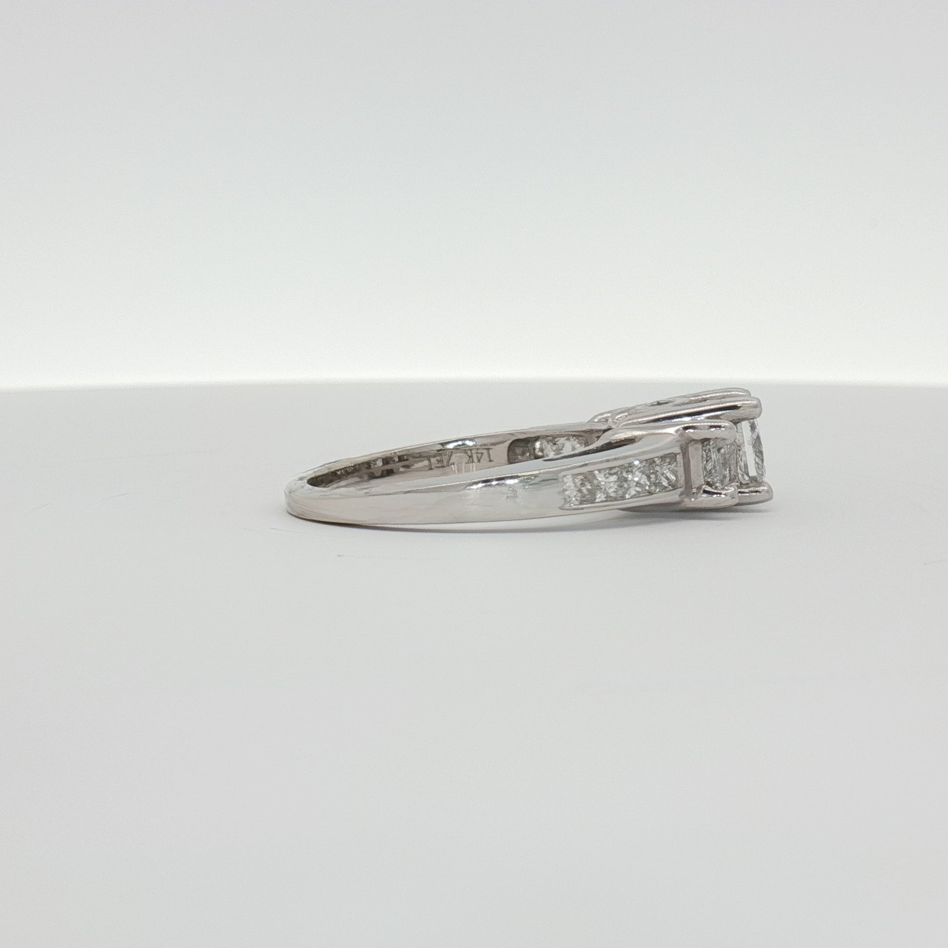 14K white gold diamond cluster ring featuring a sparkling arrangement of small diamonds in elegant jewelry style.