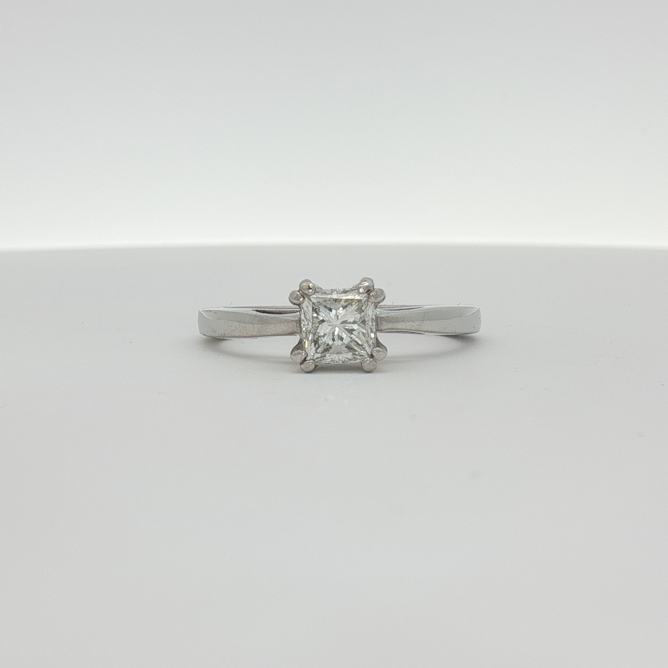Platinum diamond solitaire engagement ring by Gold & Beyond with a sparkling central diamond and sleek band design.