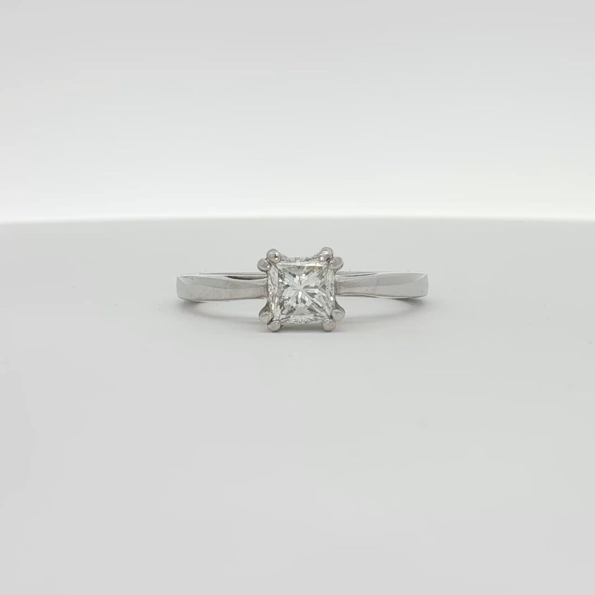 Platinum diamond solitaire engagement ring with a central sparkling diamond set on a sleek platinum band, by Gold & Beyond.