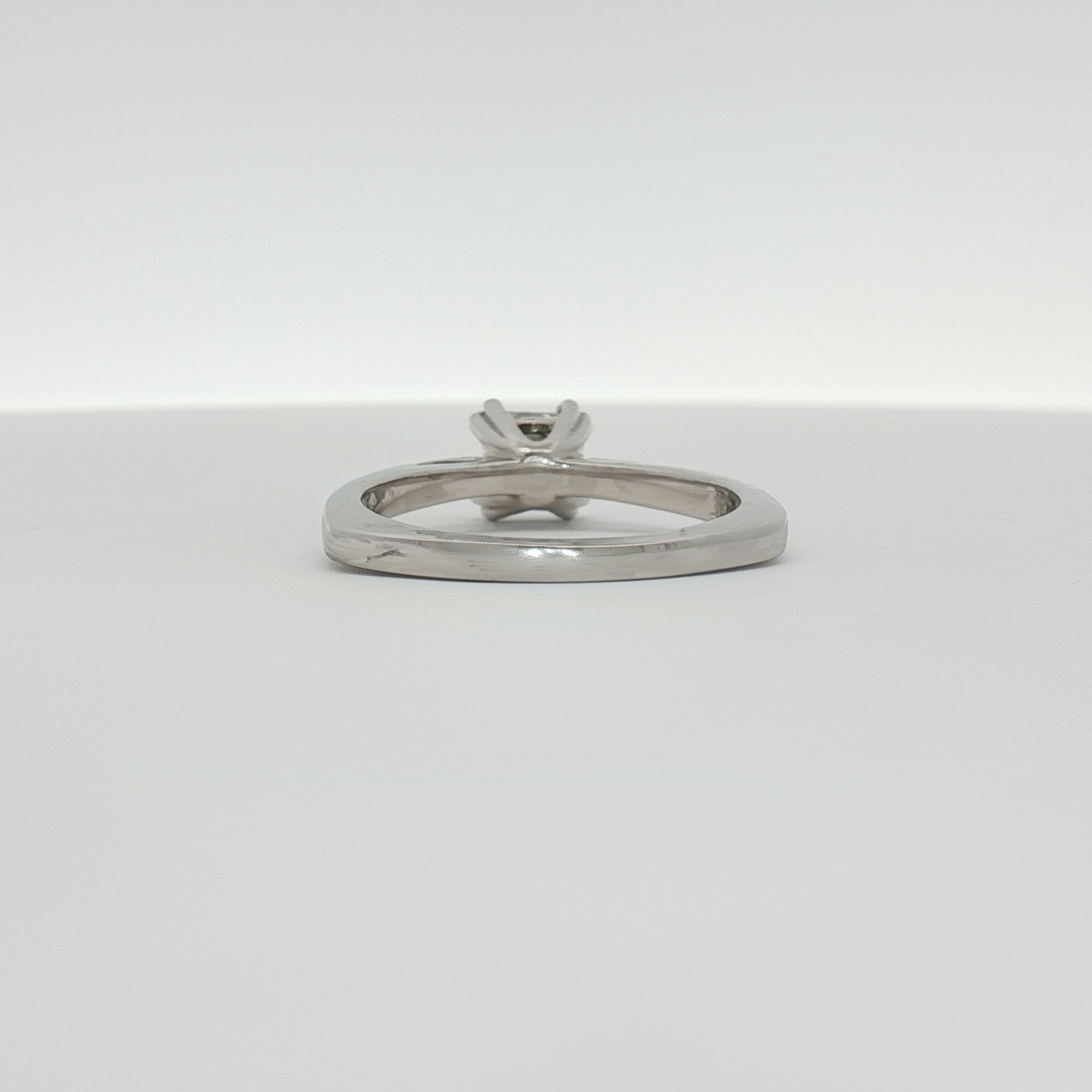Platinum diamond solitaire engagement ring with a central brilliant cut diamond set in a sleek platinum band, by Gold & Beyond.