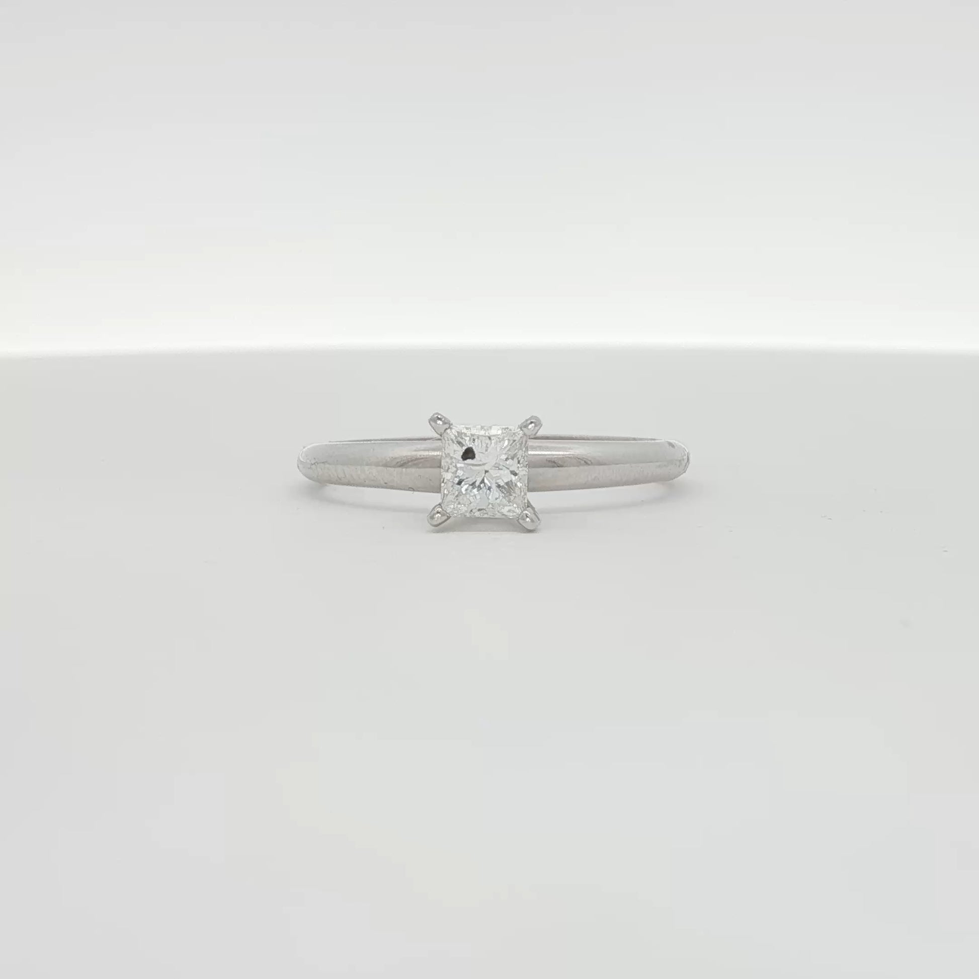 14K white gold diamond solitaire engagement ring featuring a central sparkling diamond and a sleek, elegant band.