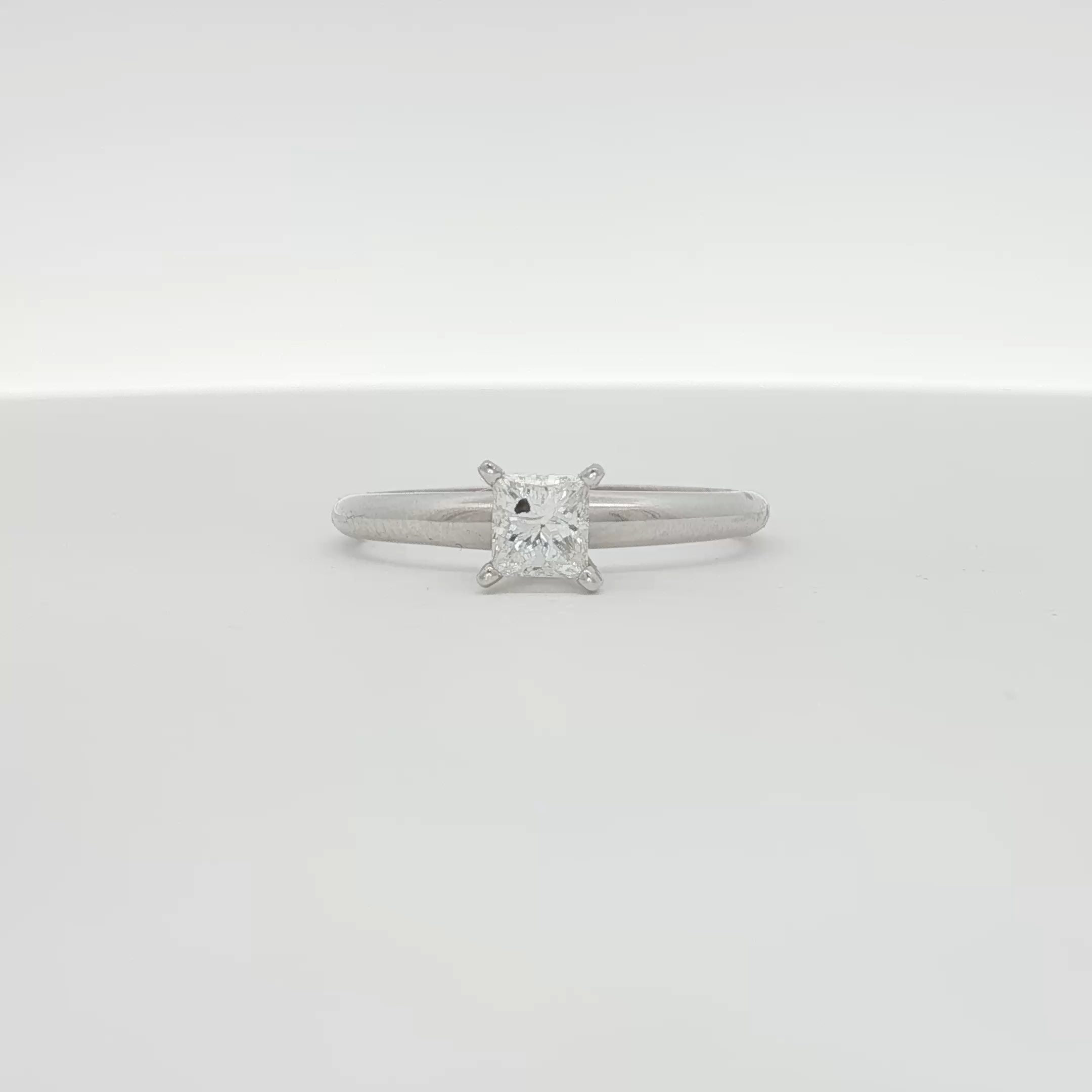 14K white gold diamond solitaire engagement ring featuring a central sparkling diamond and a sleek, elegant band.
