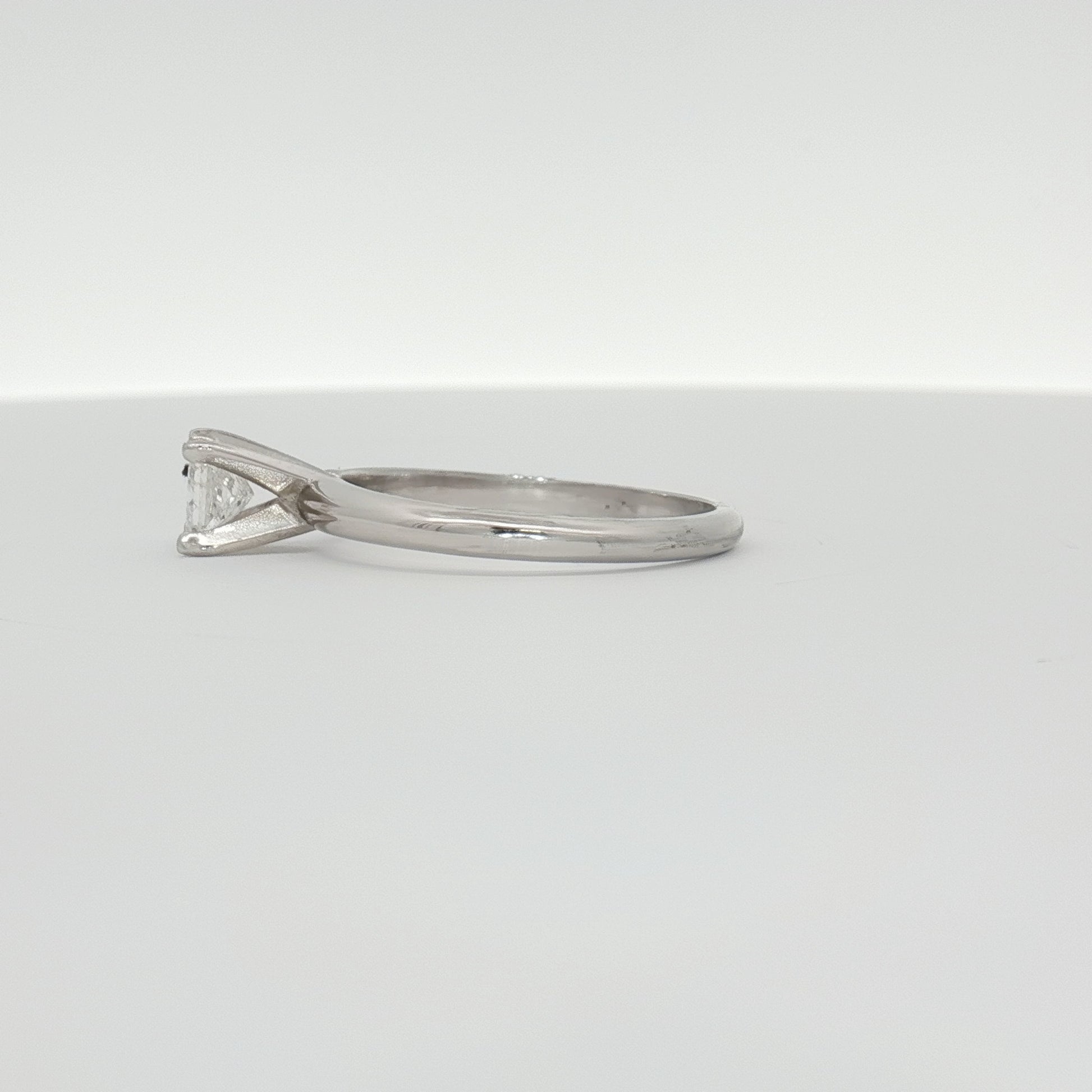 14K white gold diamond solitaire engagement ring with a central sparkling diamond and elegant band from Gold & Beyond.